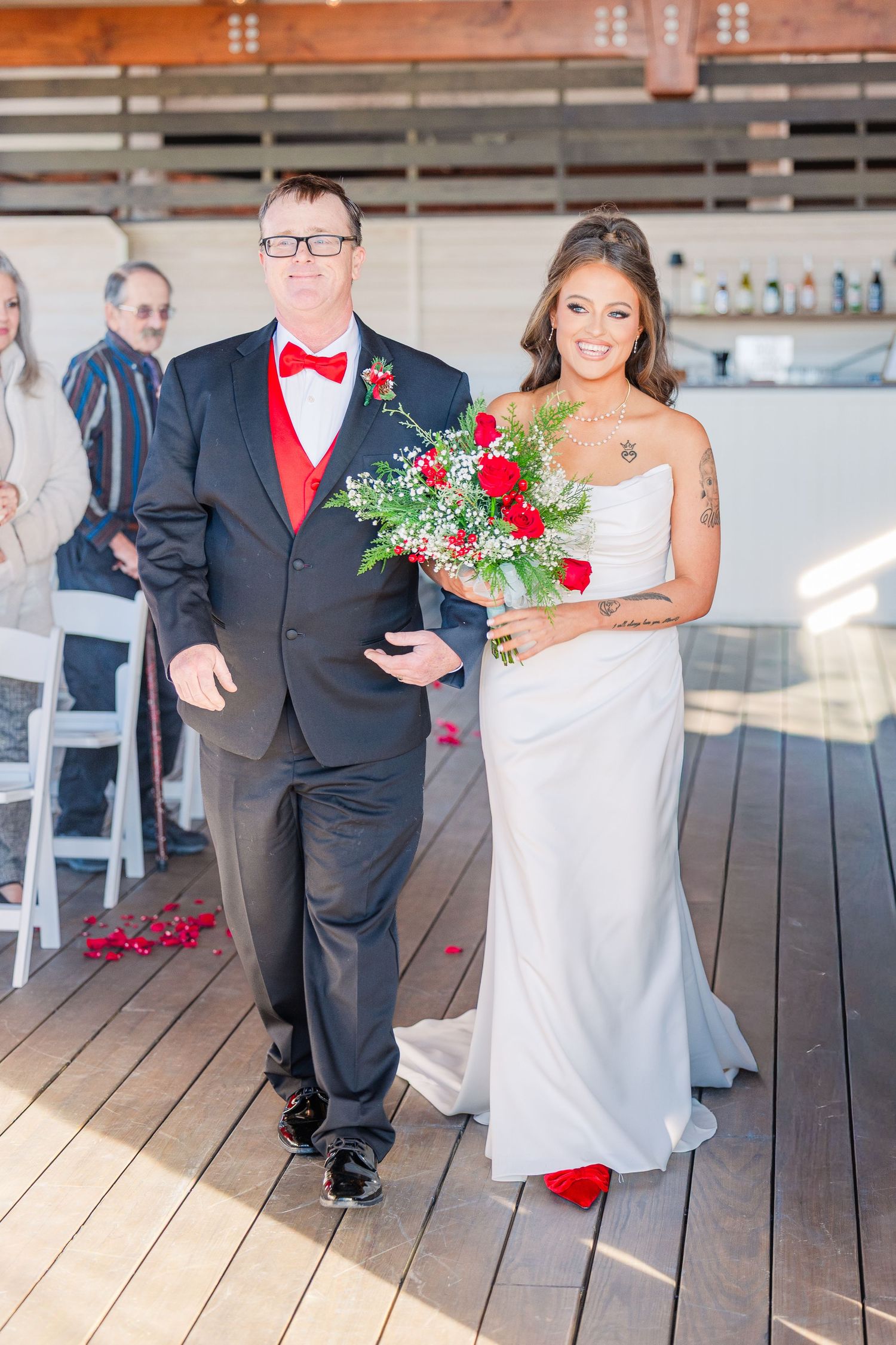 Wedding ceremony 128 south venue with red floral arrangements and formal attire wedding groom bride wilmington North Carolina photographer