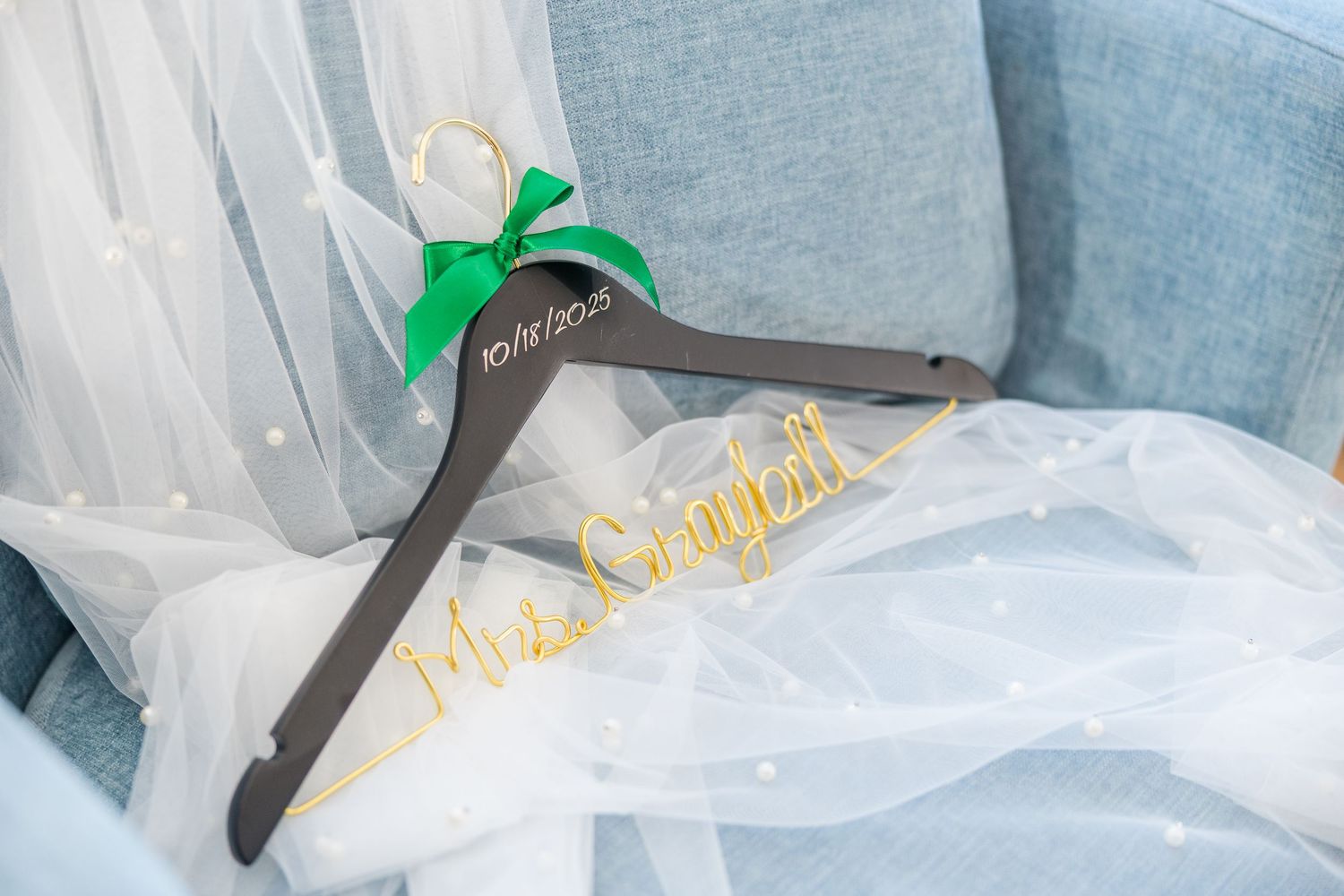Wedding decor with white fabric and gold accents against blue background wedding groom bride lake Gaston photographer light airy