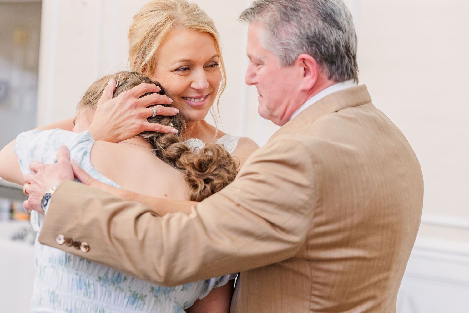 Candid moments captured during a wedding celebration in an elegant indoor venue.