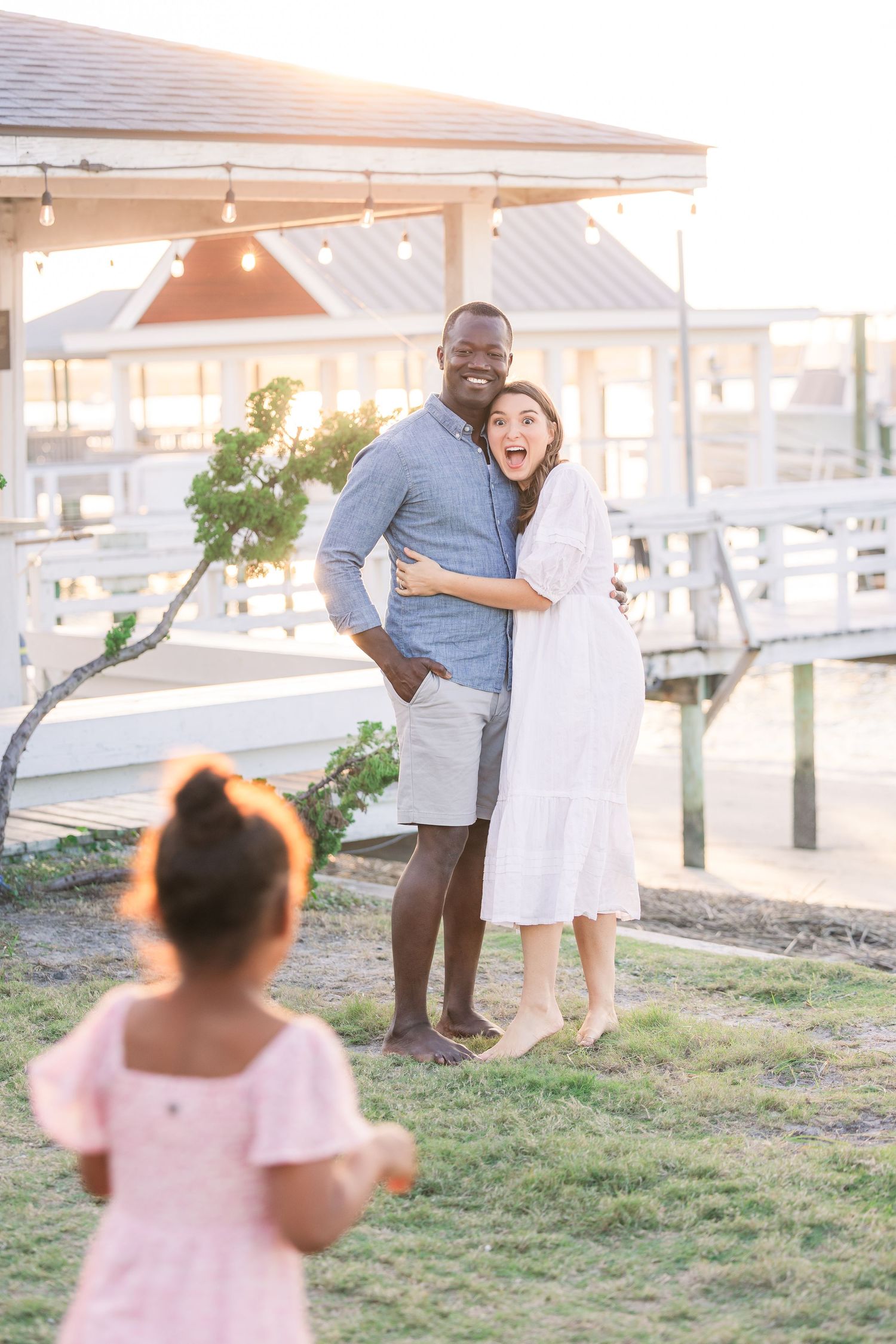 Candid family portrait showing joyful expressions during outdoor photoshoot.