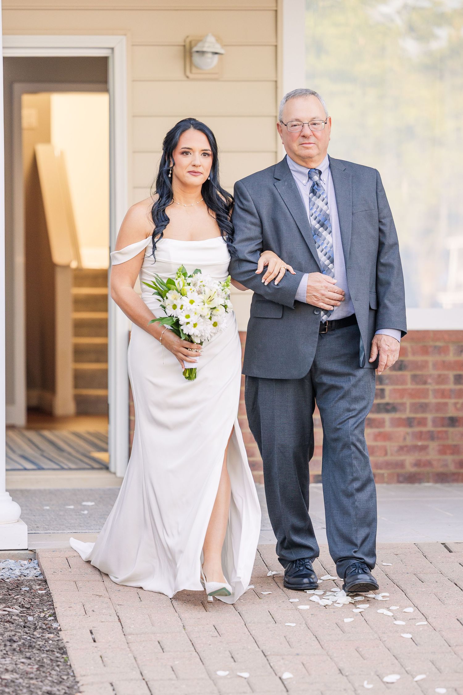 Wedding ceremony processional on stone pathway with formal attire and floral bouquet wedding groom bride lake Gaston photographer light airy