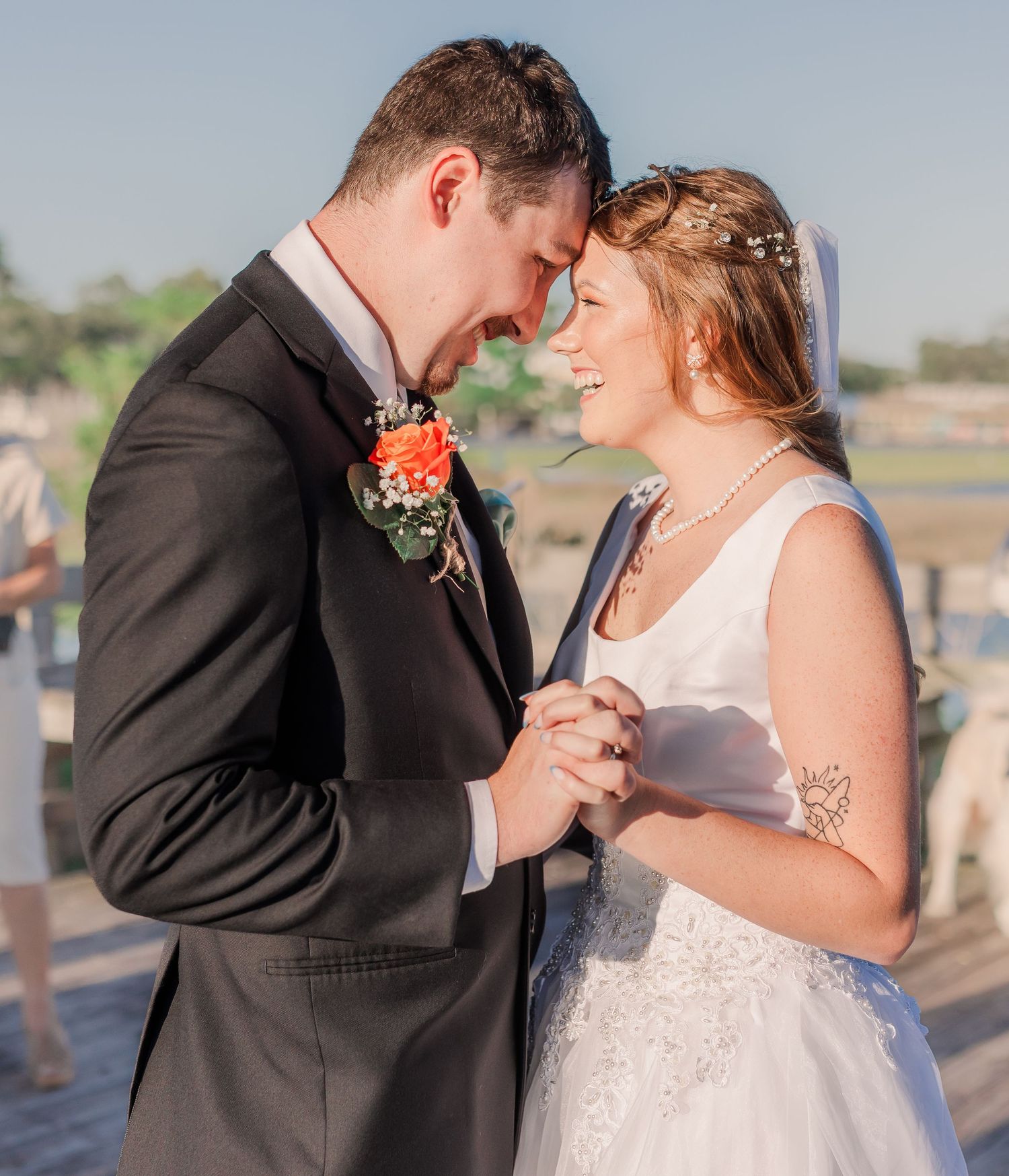 Intimate wedding moments shared between couple on seaside boardwalk southport elopement wedding bride groom light and airy classic