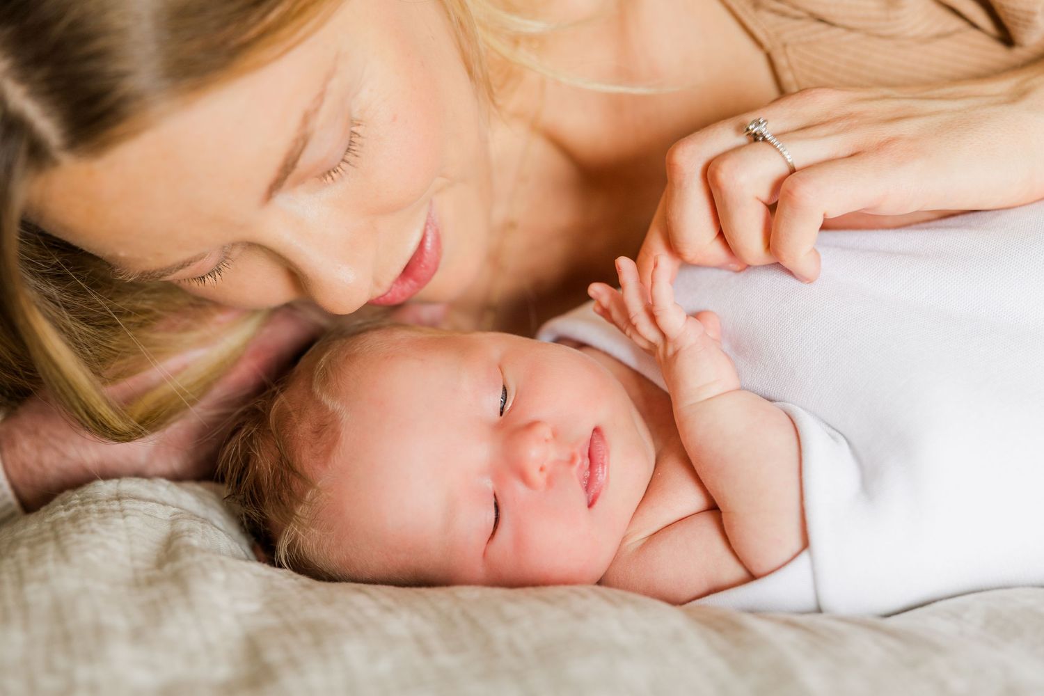 Close-up portrait of sleeping newborn baby in soft natural light.