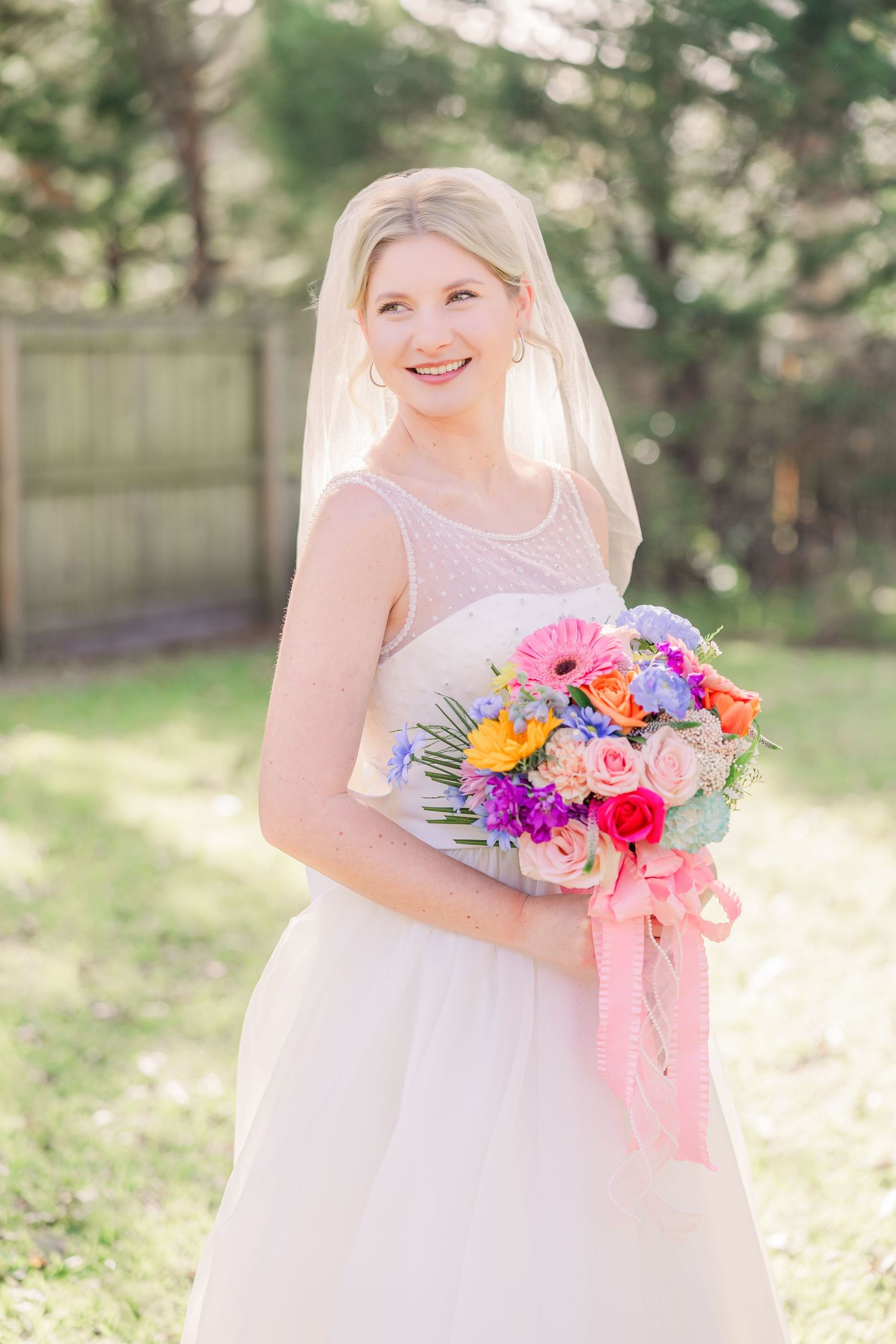 A bridal bouquet with vibrant pink and purple flowers wedding groom bride wilmington photographer light and airy classic Wrightsville Beach