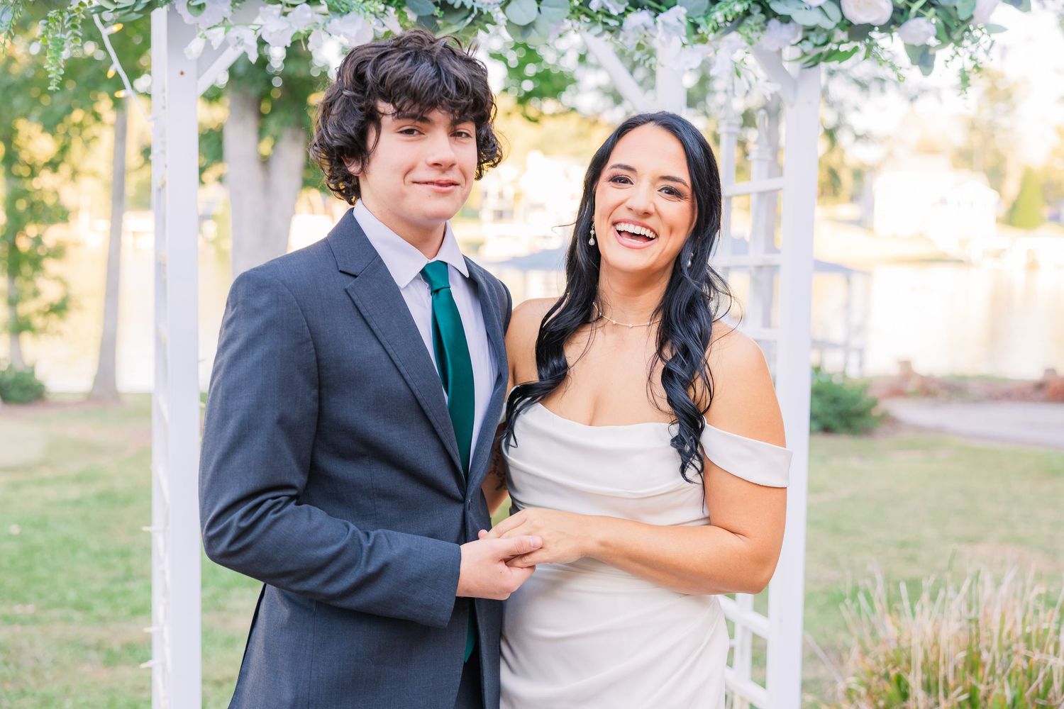 A romantic wedding photo series showing a couple embracing on a sunny autumn day wedding groom bride lake Gaston photographer light airy