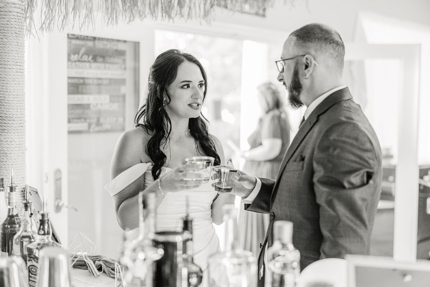 Wedding reception venue with elegant white decor and hanging decorations wedding groom bride lake Gaston photographer light airy