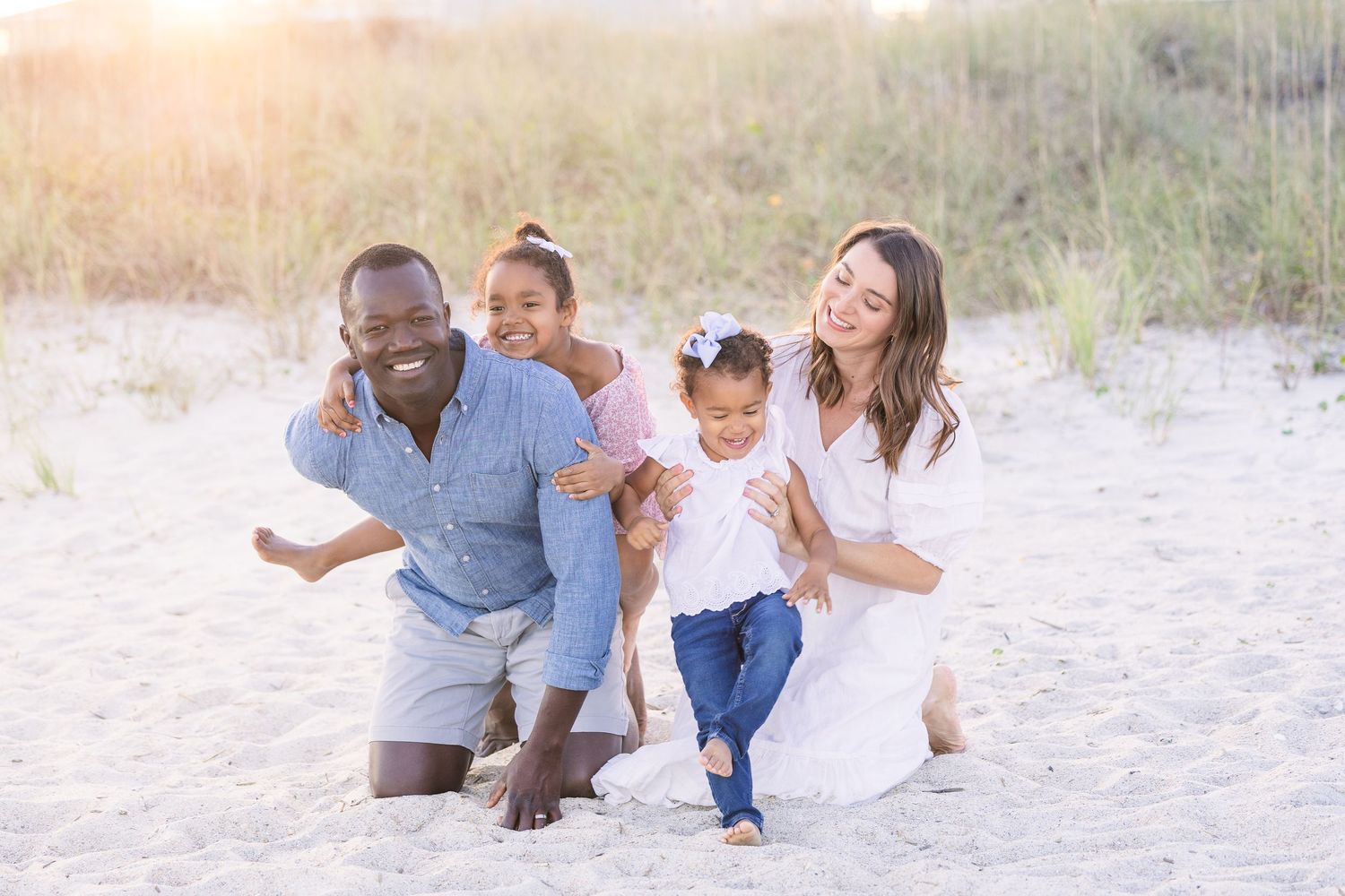Family sharing tender moments together during a sunset beach photography session.
