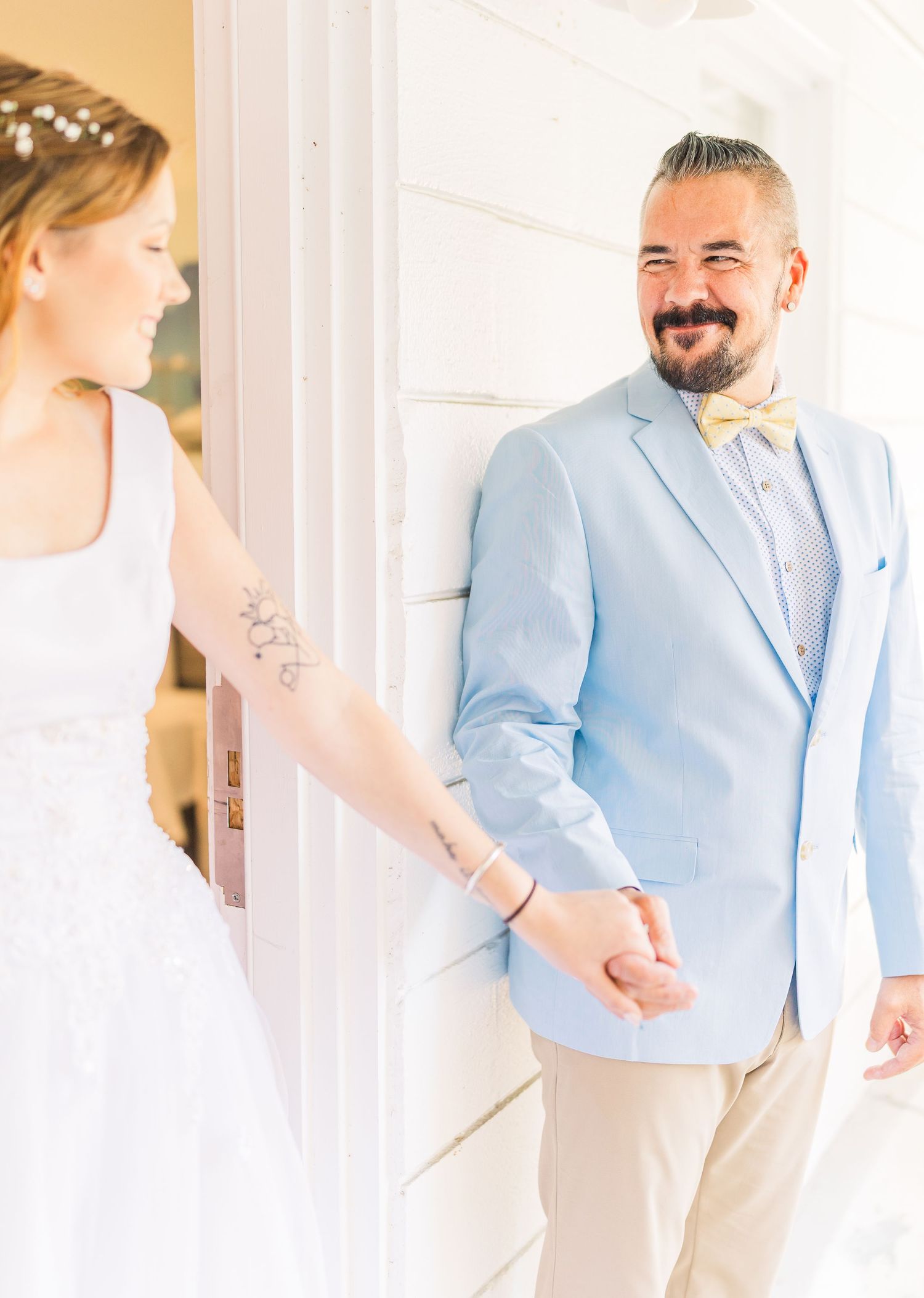 Emotional first look between bride and groom in light blue suit southport elopement wedding bride groom light and airy classic