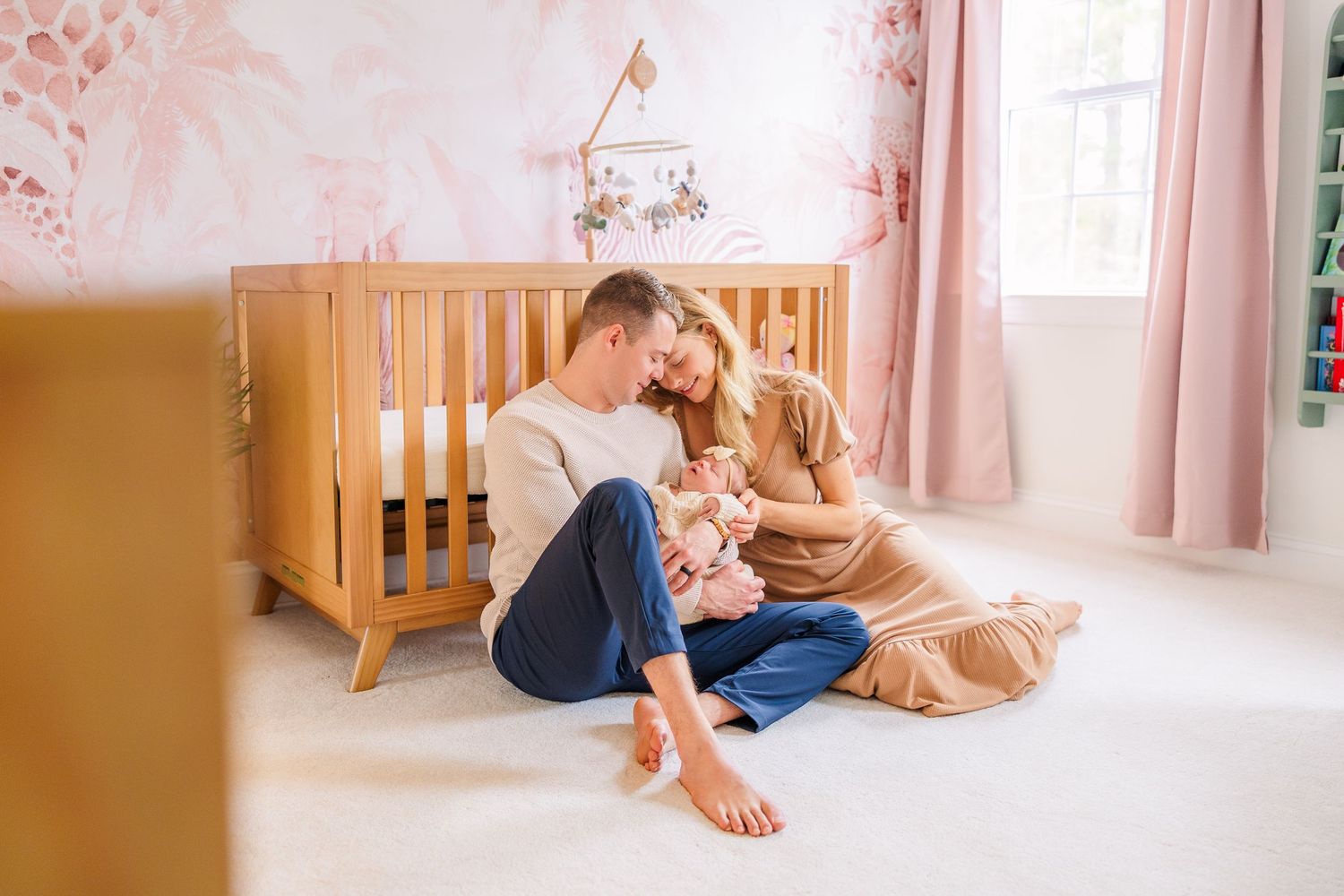 Family lifestyle session photographed in a nursery with warm wooden accents.