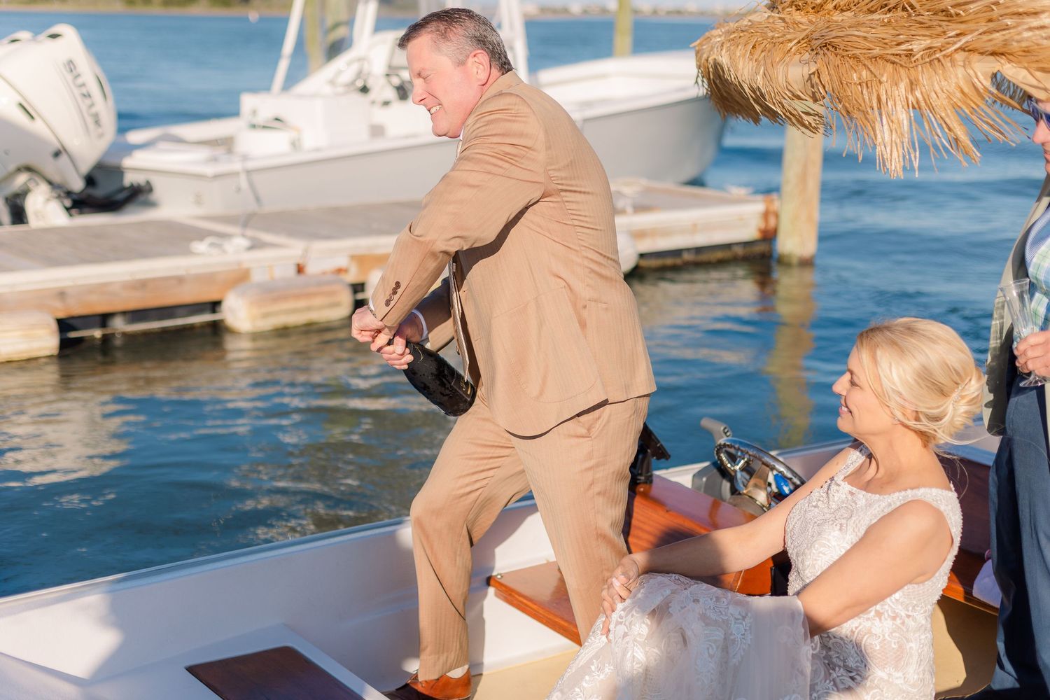 A celebratory moment captured on a boat dock with water and boats in the background.