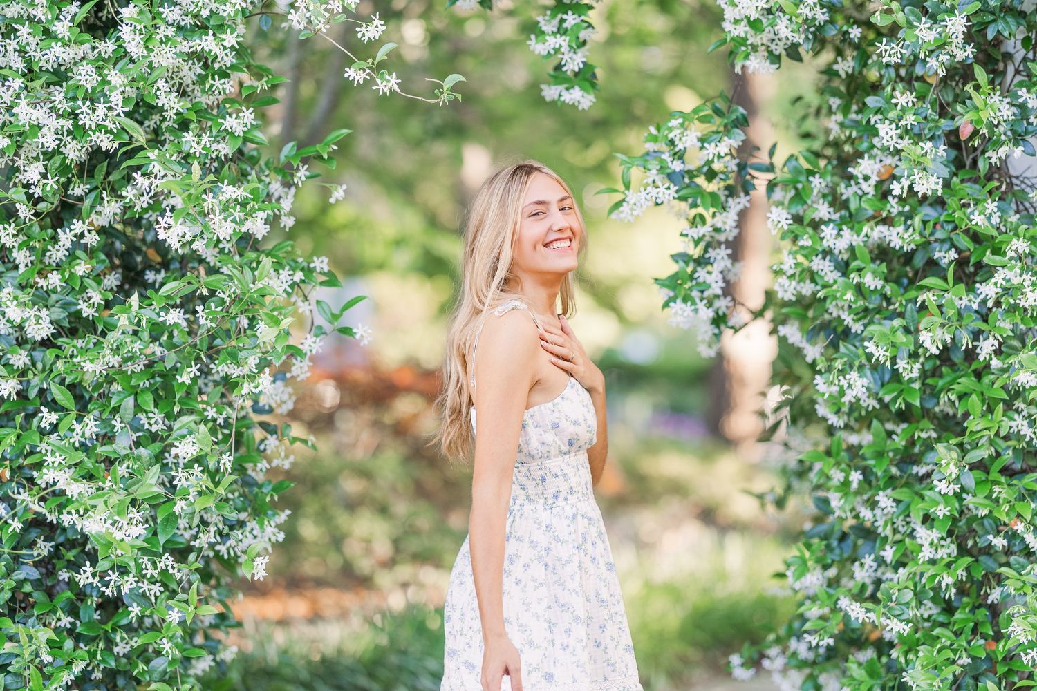 Whimsical outdoor photoshoot under flowering trees in springtime.