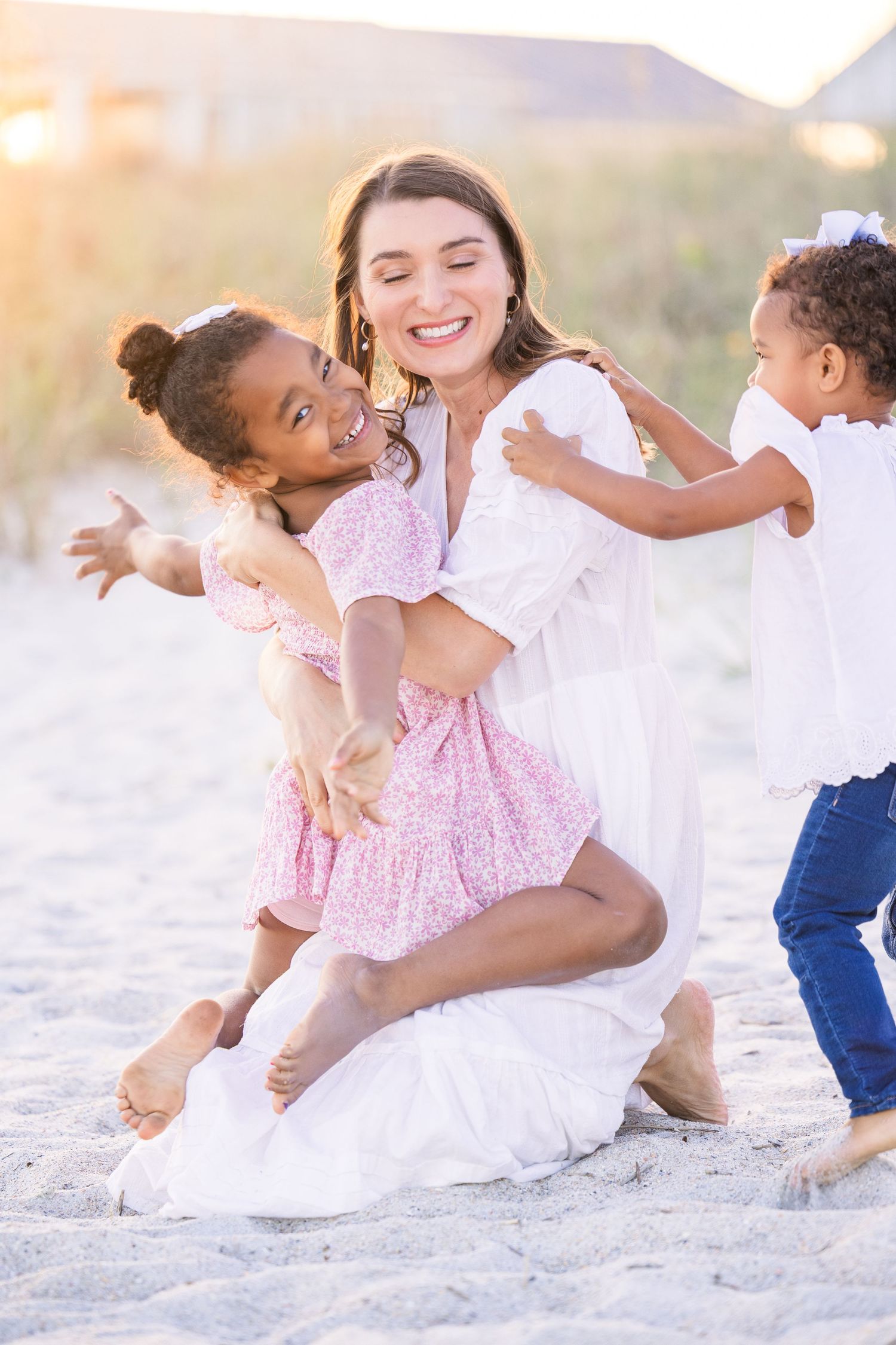 Candid family photos showing joyful interactions on a sandy beach during golden hour.