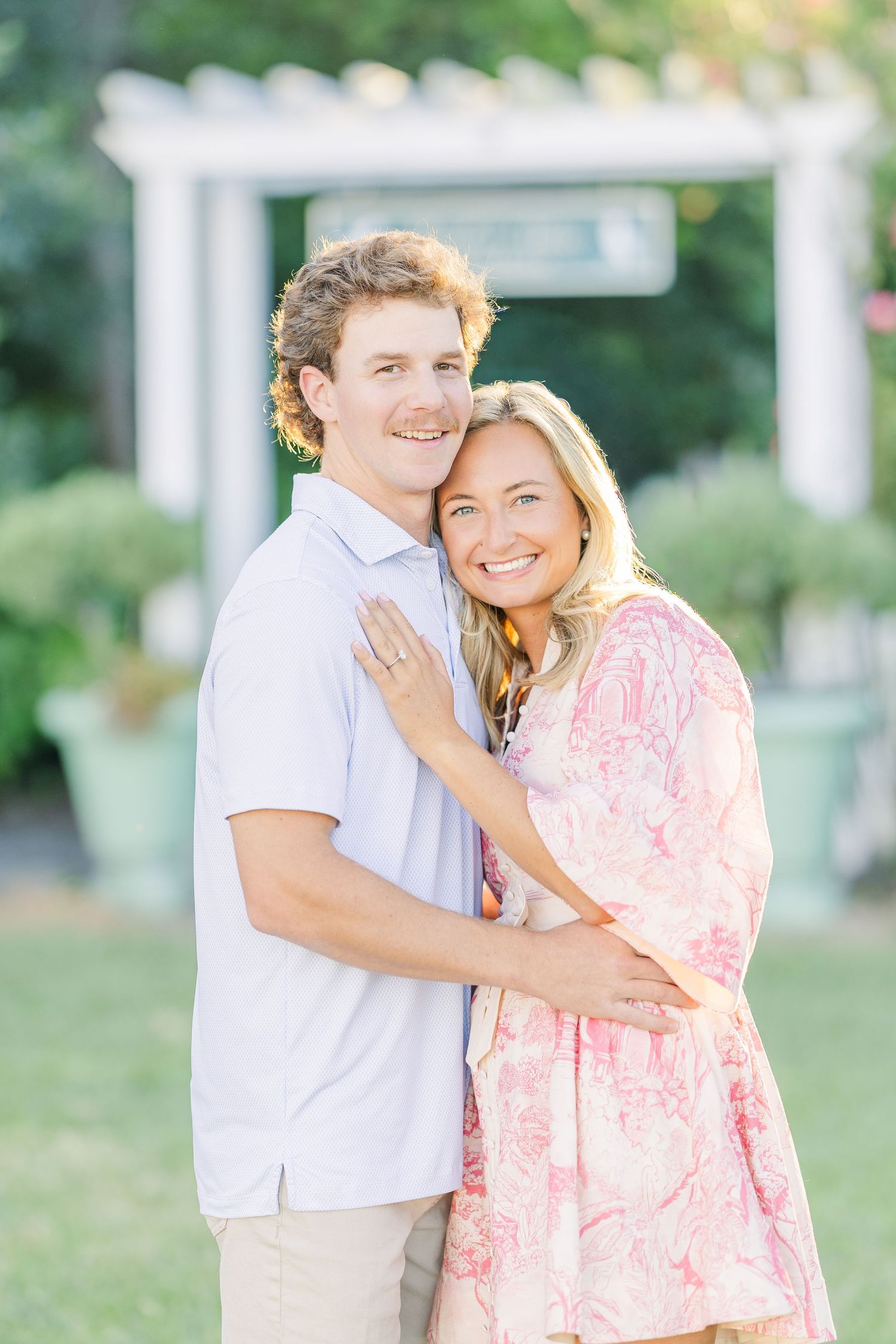 Sweet embrace captured in a garden with soft natural lighting.