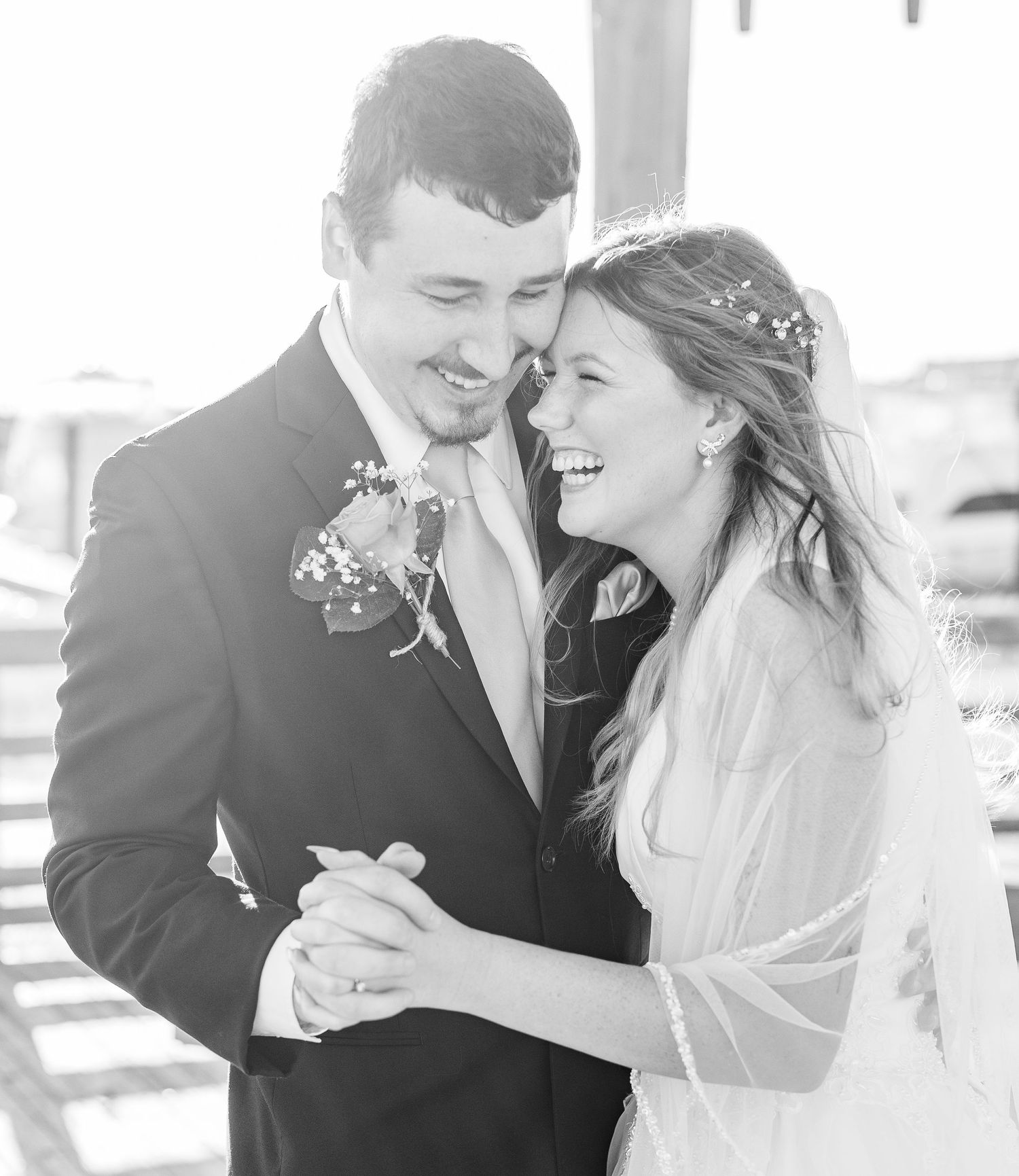 Black and white wedding photos showing tender moments between a couple.