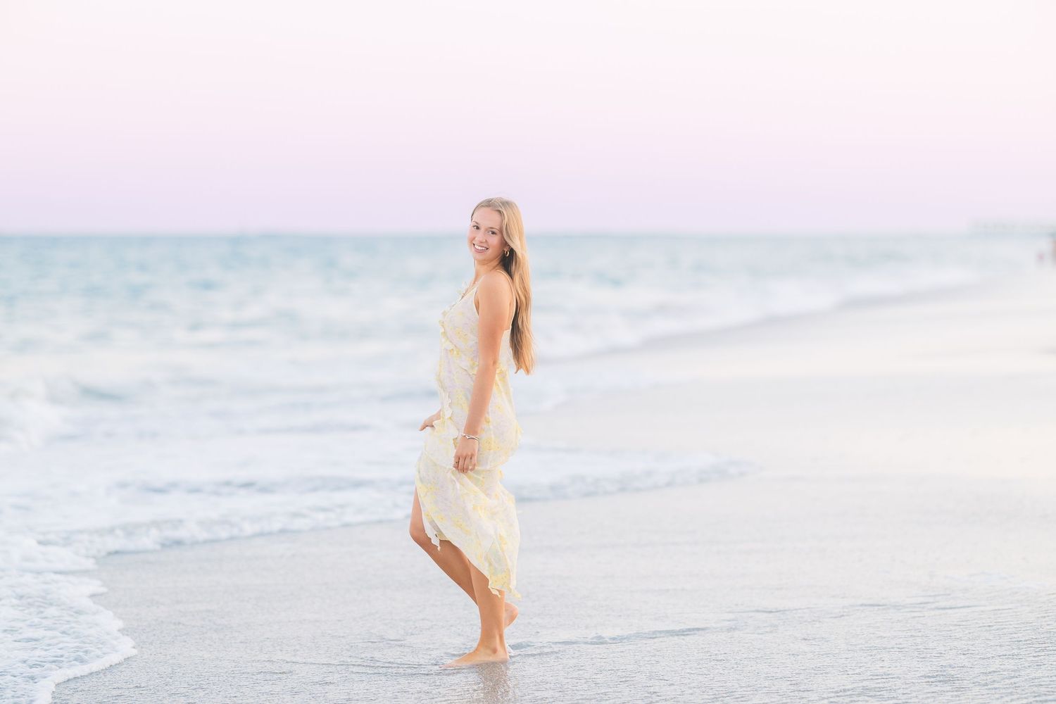 Ethereal beach photography with soft pastel colors and ocean waves.