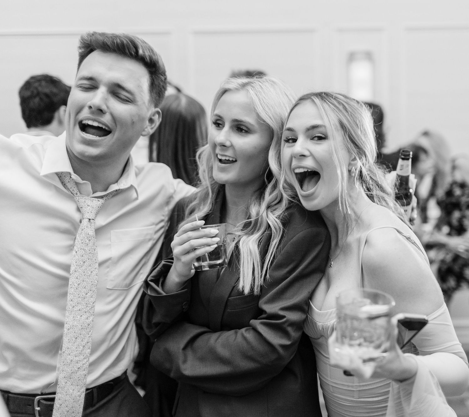 Black and white photo of guests laughing and dancing  landfall wedding bride groom light and airy classic wilmington Wrightsville Beach