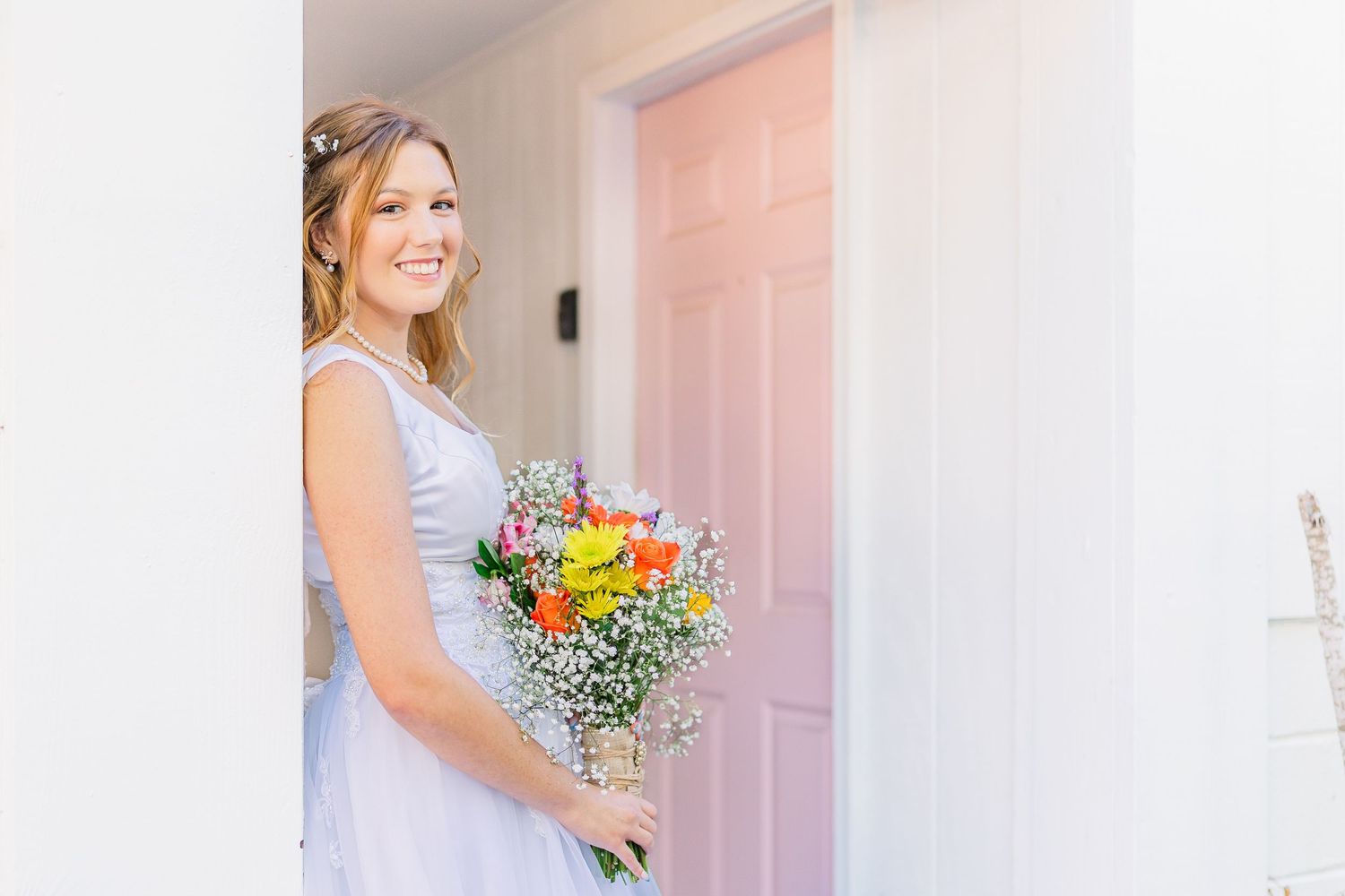 Bridal portraits with colorful bouquet against white walls and pink door southport elopement wedding bride groom light and airy classic