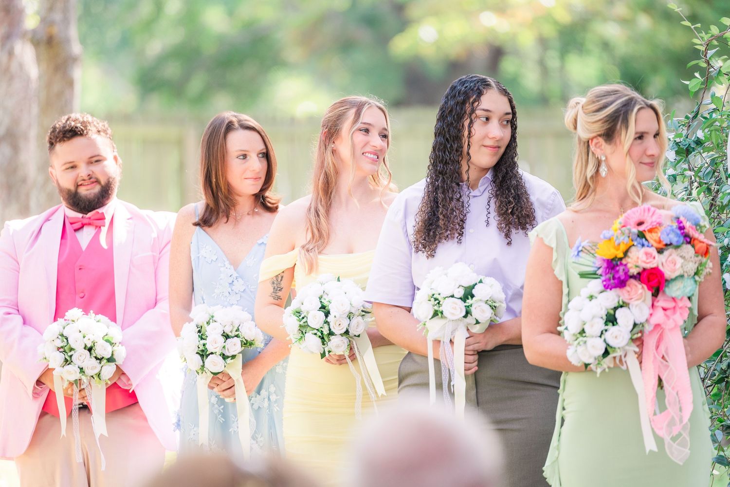 Wedding party members in pastel pink and mint green dresses wedding groom bride wilmington photographer light and airy classic Wrightsville