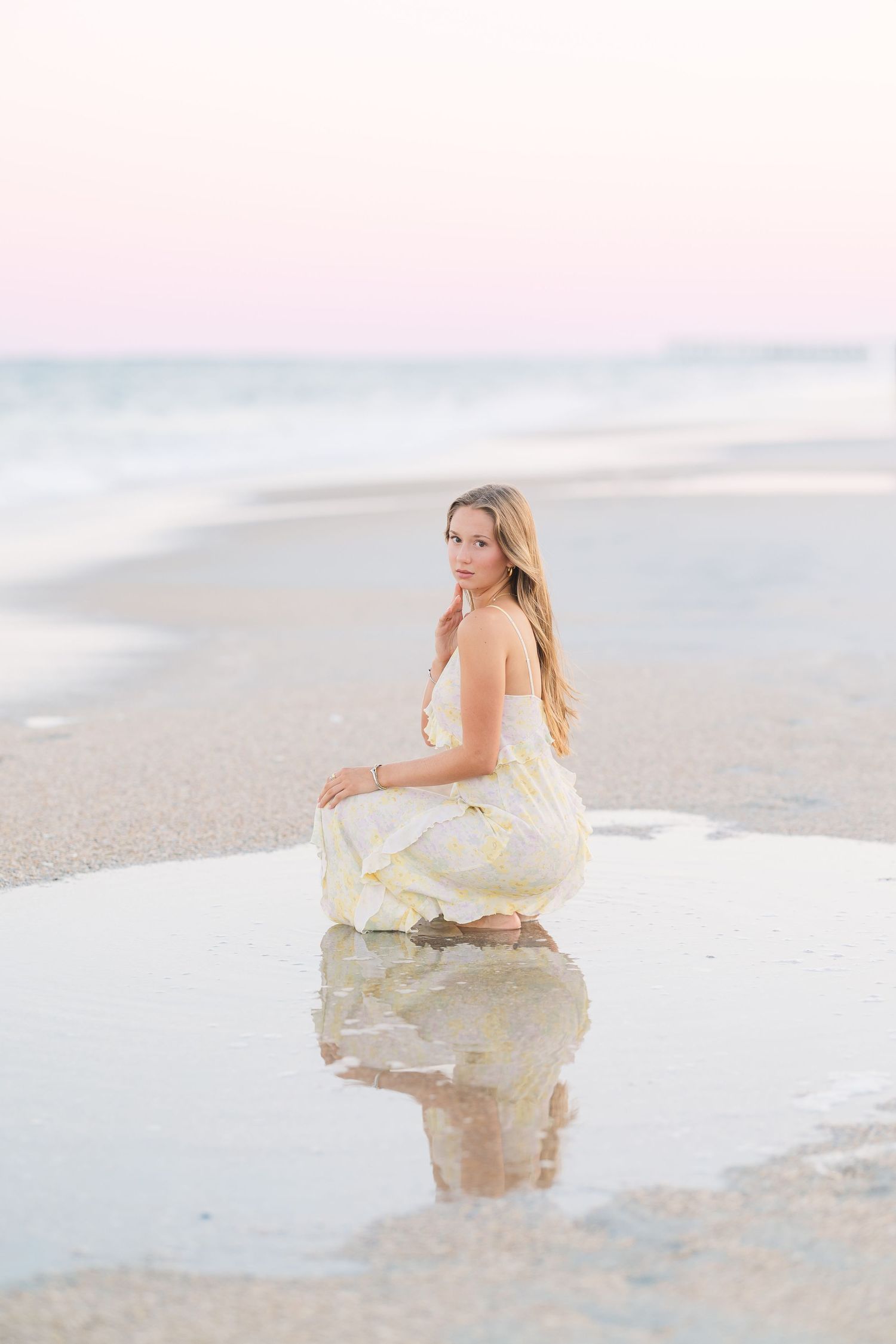 Dreamy beach portraits with reflection in water during sunset.