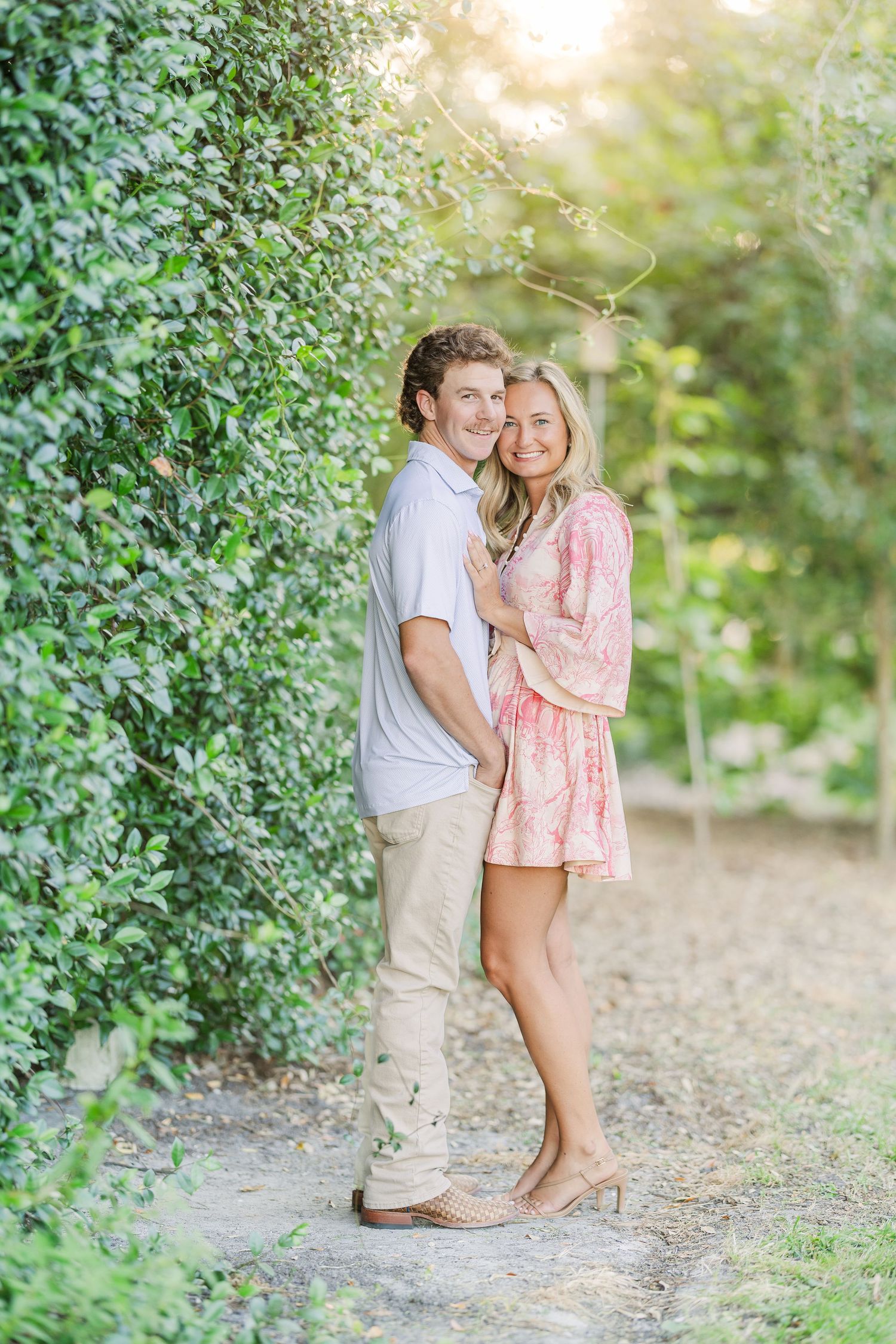 Intimate garden photoshoot among green foliage with natural lighting.