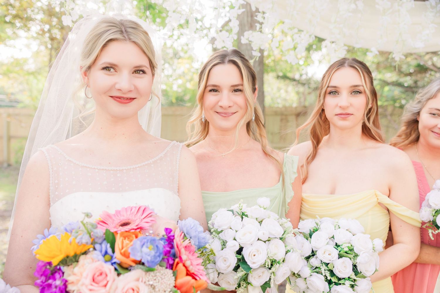 Wedding party holds contrasting bouquets of vibrant colors and pure white flowers wedding groom bride wilmington photographer light and airy