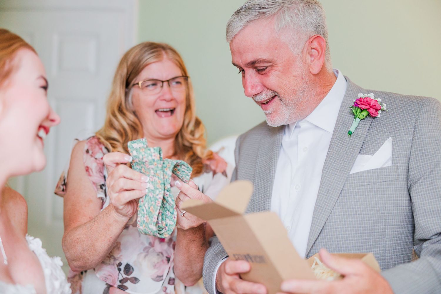 A heartwarming moment of laughter and gift-giving at a wedding celebration in a backyard wedding in wilmington, nc