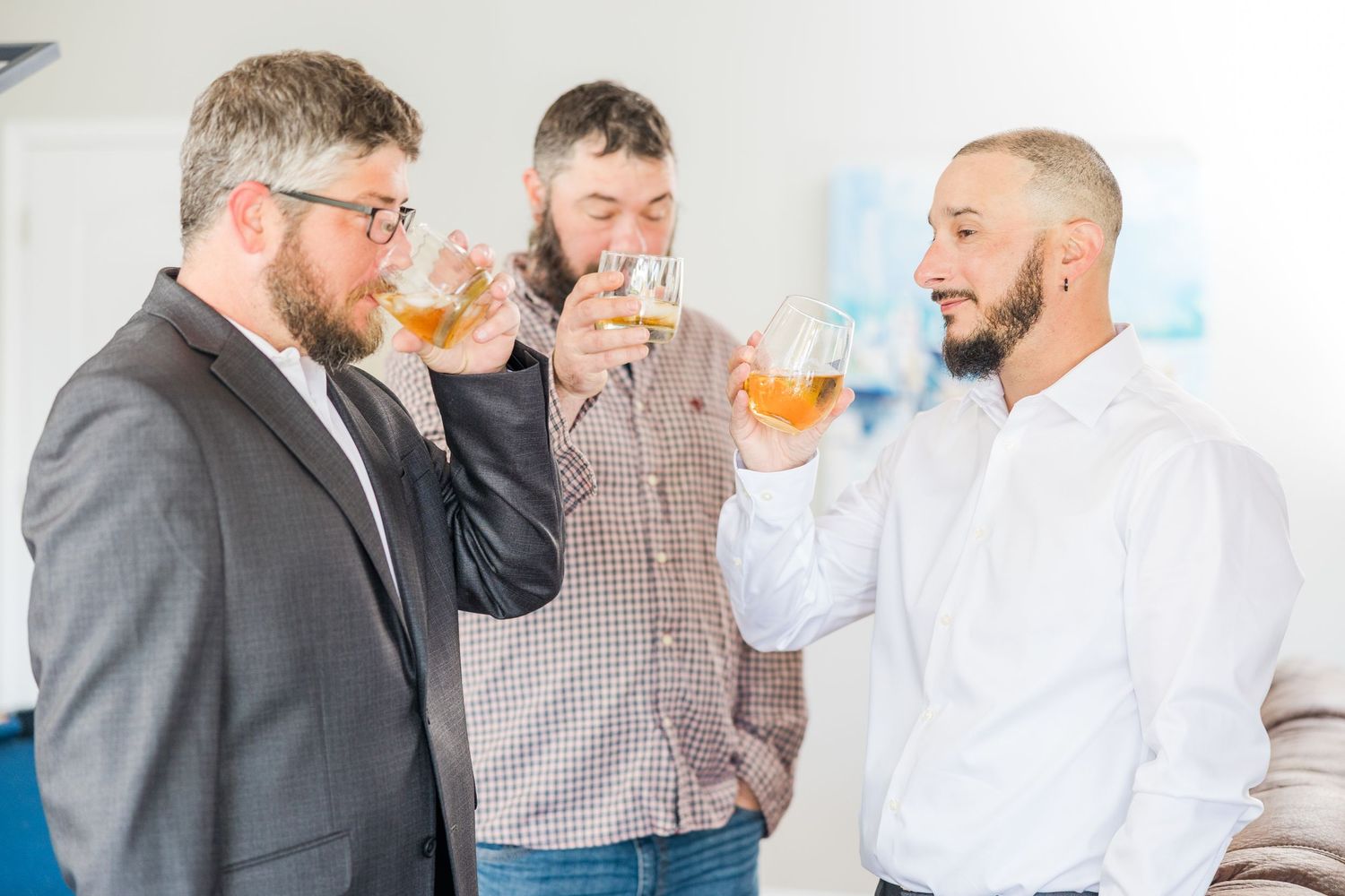 Friends enjoying drinks and conversation at formal gathering wedding groom bride lake Gaston photographer light airy