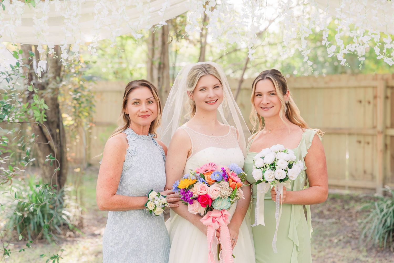 Wedding party members in garden backdrop wedding groom bride wilmington photographer light and airy classic Wrightsville Beach