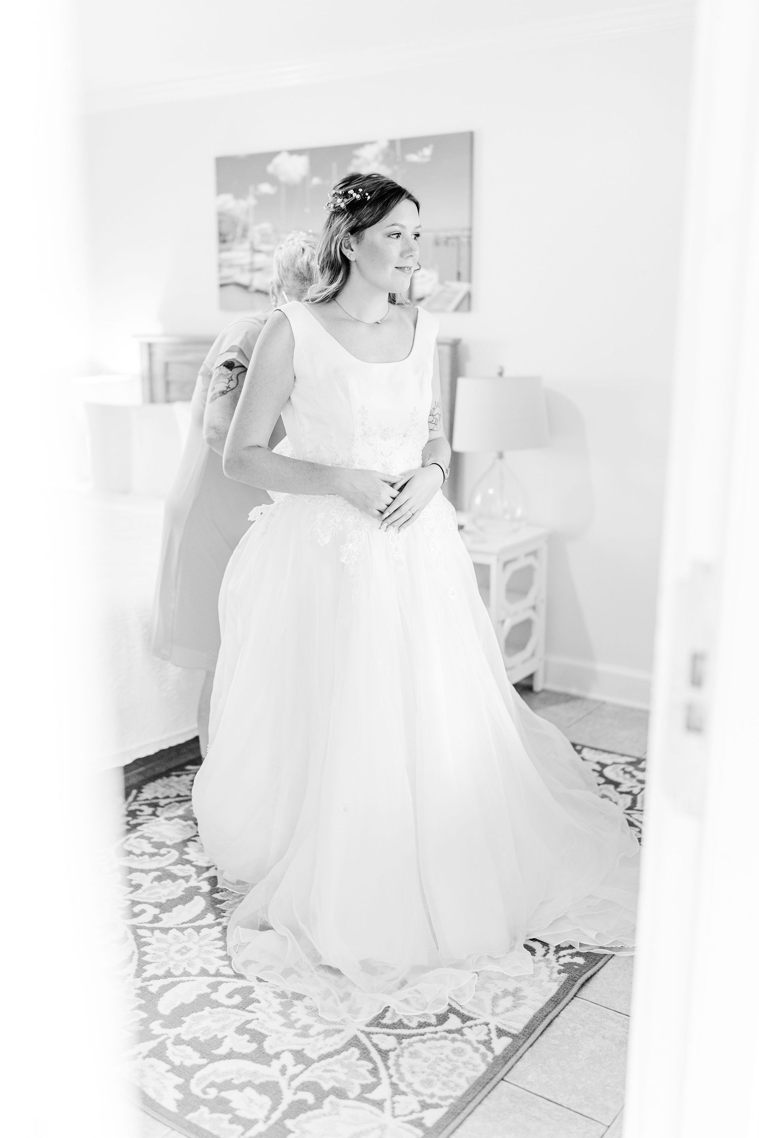 Bride twirls in flowing white wedding gown against light background southport elopement wedding bride groom light and airy classic