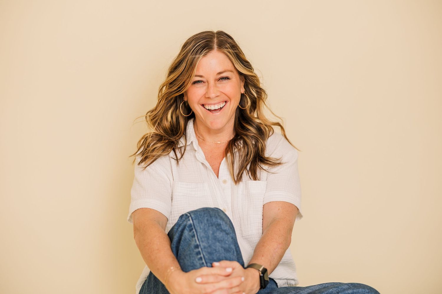 Natural lifestyle portraits in casual attire against beige studio background.