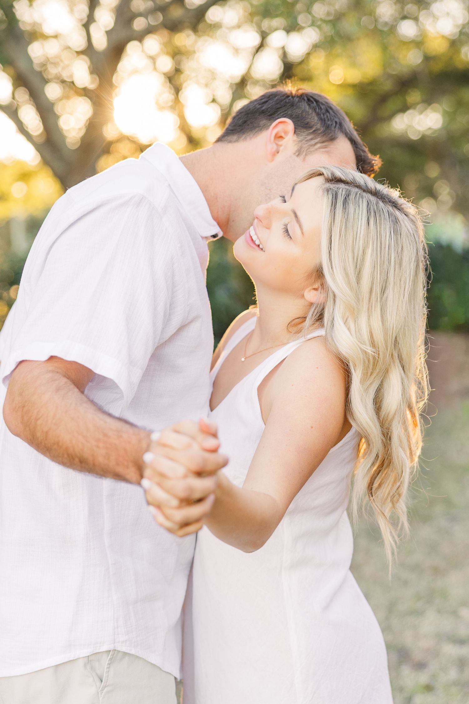 Candid moments of a couple dancing and laughing together in an outdoor setting.