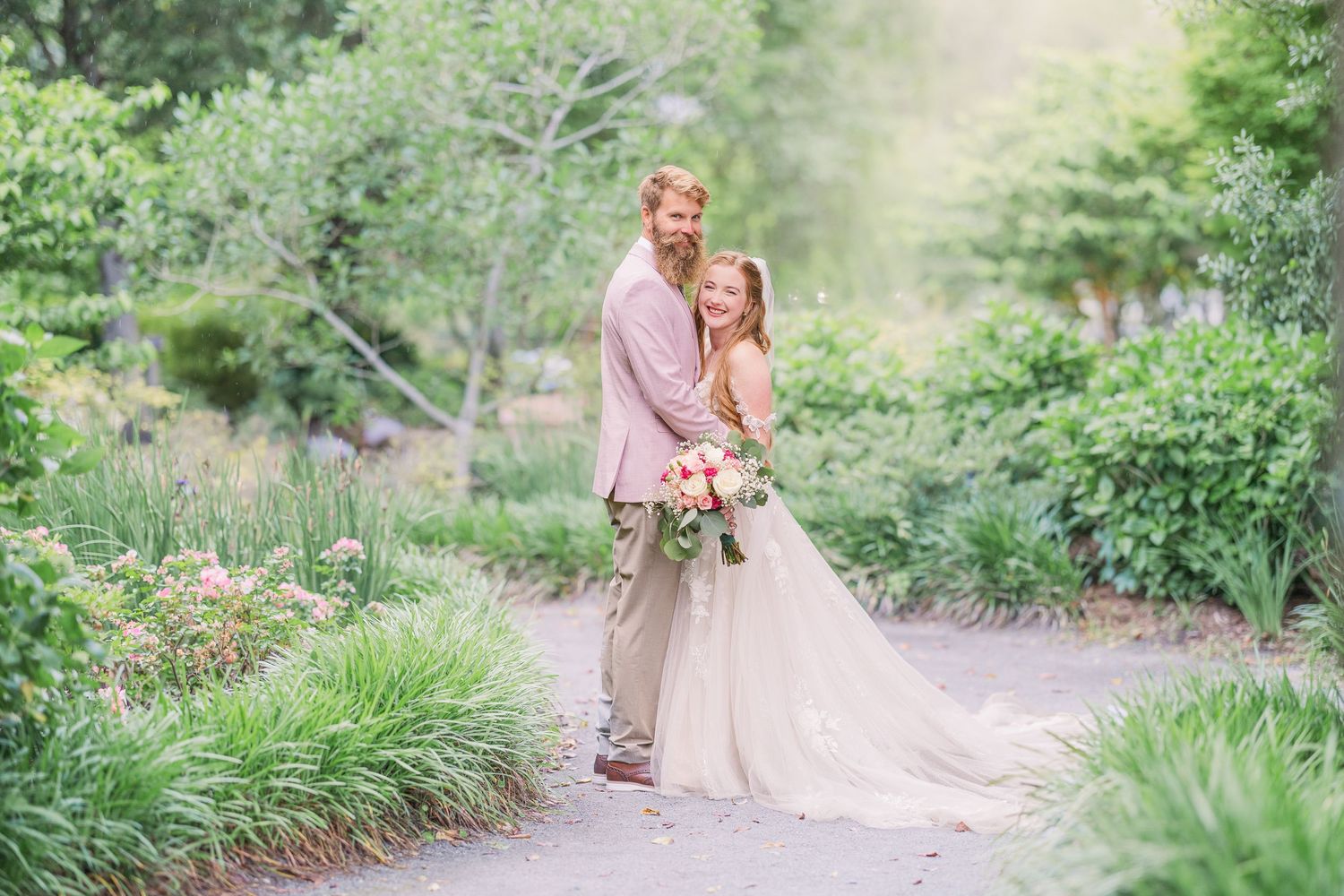 Romantic garden wedding photoshoot with couple in soft pink and beige tones.