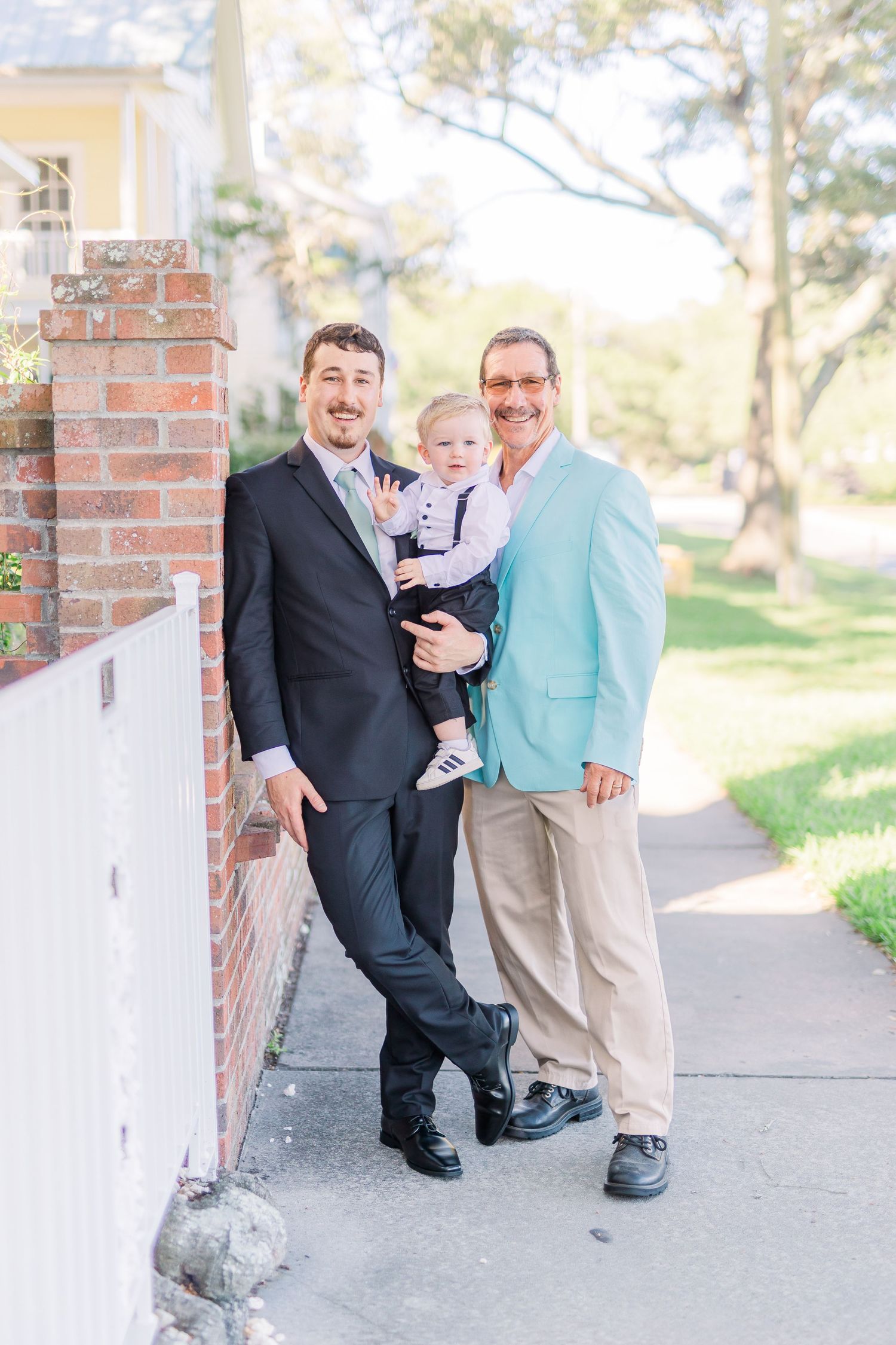Family portrait session outside brick building with formal attire southport elopement wedding bride groom light and airy classic