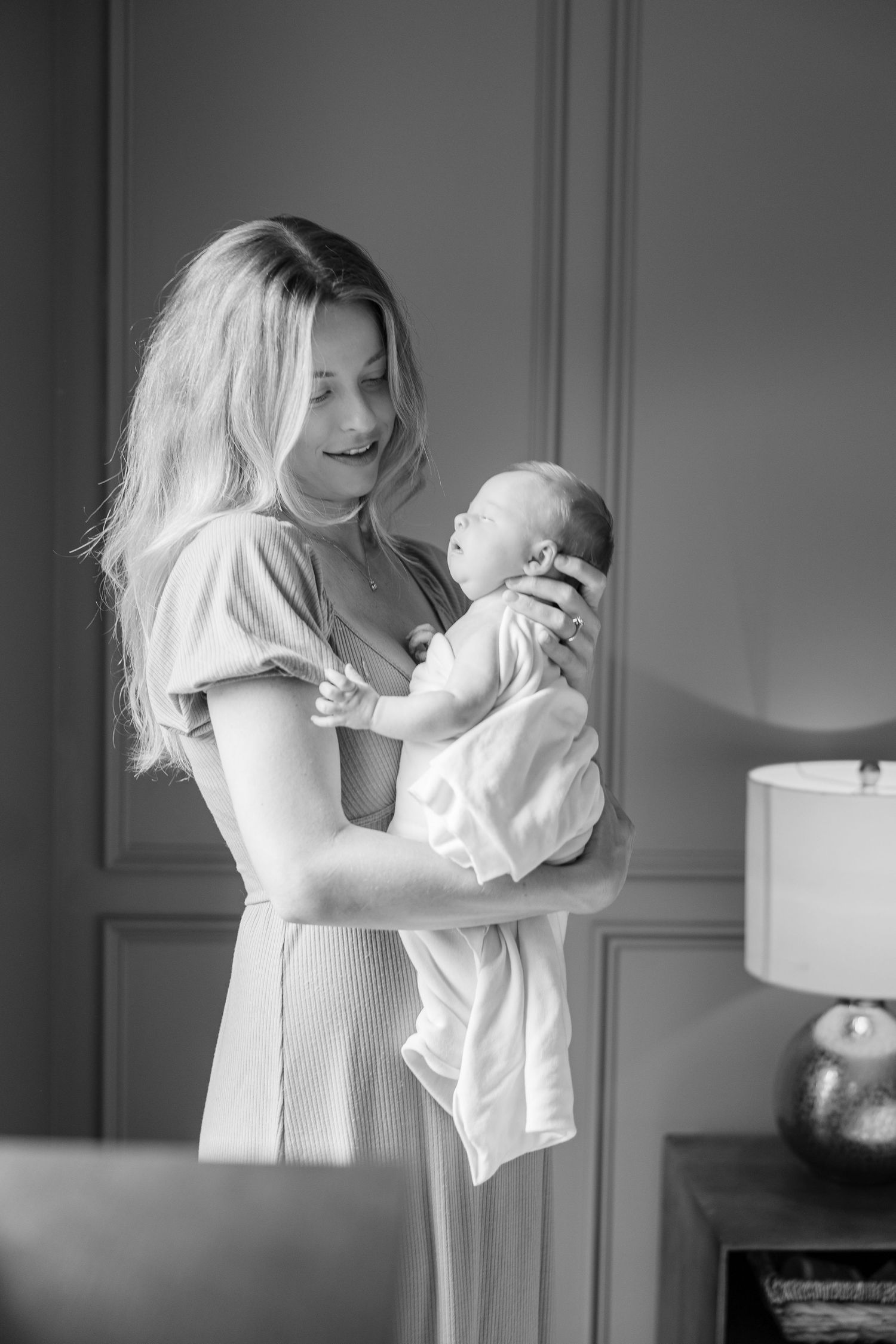 Black and white series of tender moments between parent and infant.