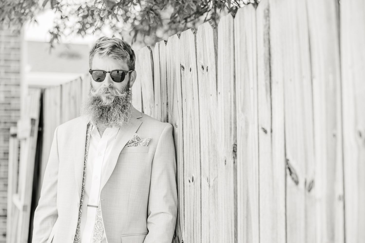 Black and white portrait against a wooden fence backdrop wedding groom bride wilmington North Carolina photographer light and airy