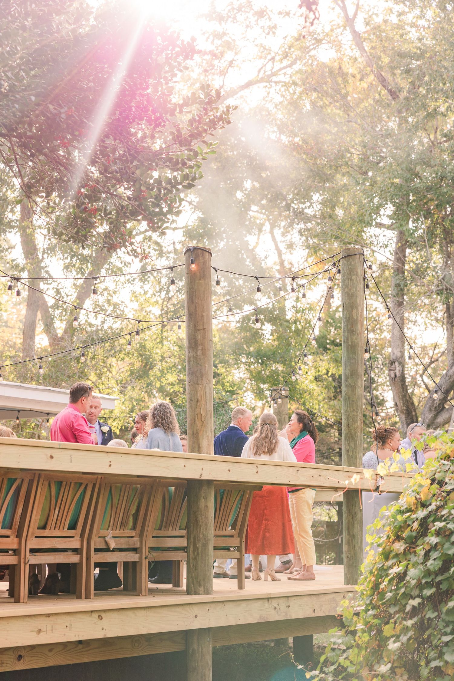 wedding guests during golden hour celebration wedding groom bride wilmington photographer light and airy classic Wrightsville Beach