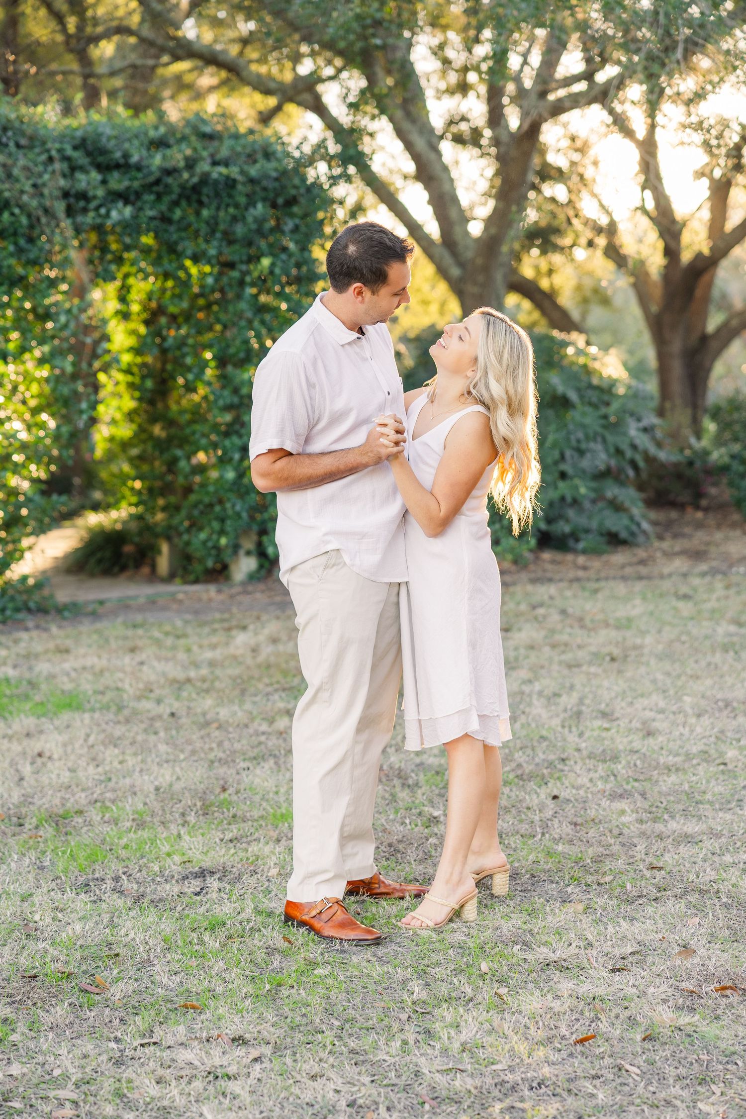 Romantic dance sequence photos of a couple in matching white outfits at sunset.