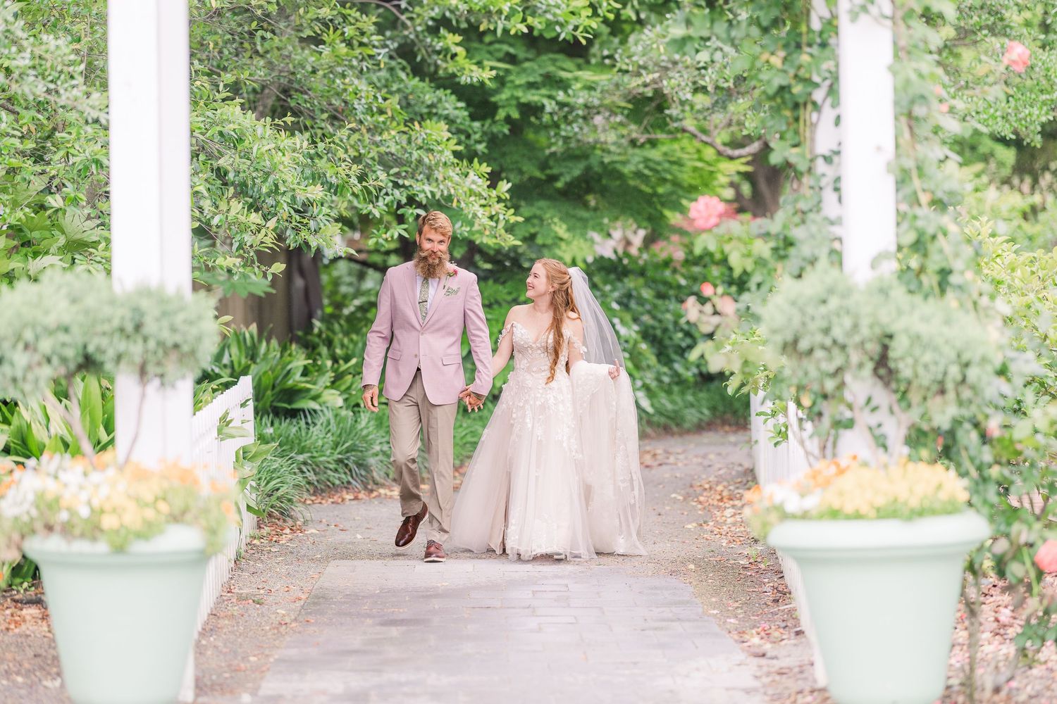 Elegant garden wedding photography featuring manicured paths and blooming spring landscaping in harborway gardens in Wrightsville Beach, nc