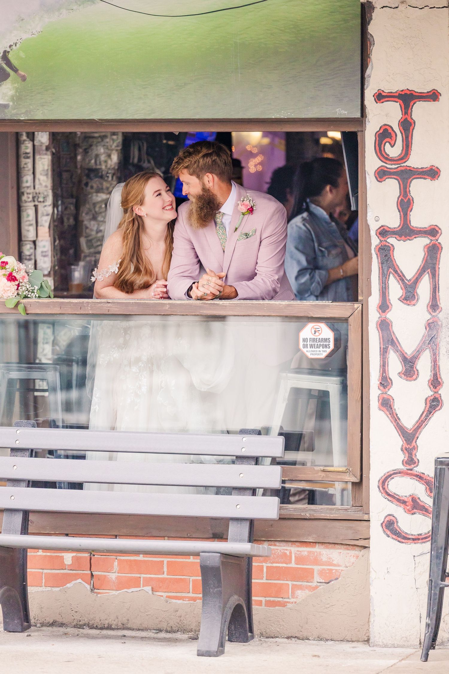 Wrightsville Beach bride and groom in jimmys dive bar embracing in a sweet moment after their wedding