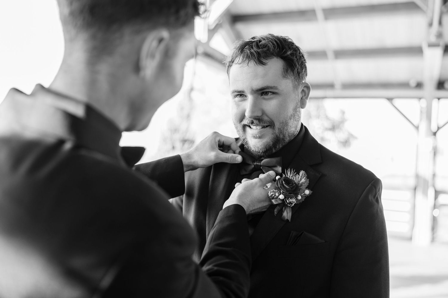 Candid moments between wedding party members in formal attire wedding groom bride wilmington North Carolina photographer light airy