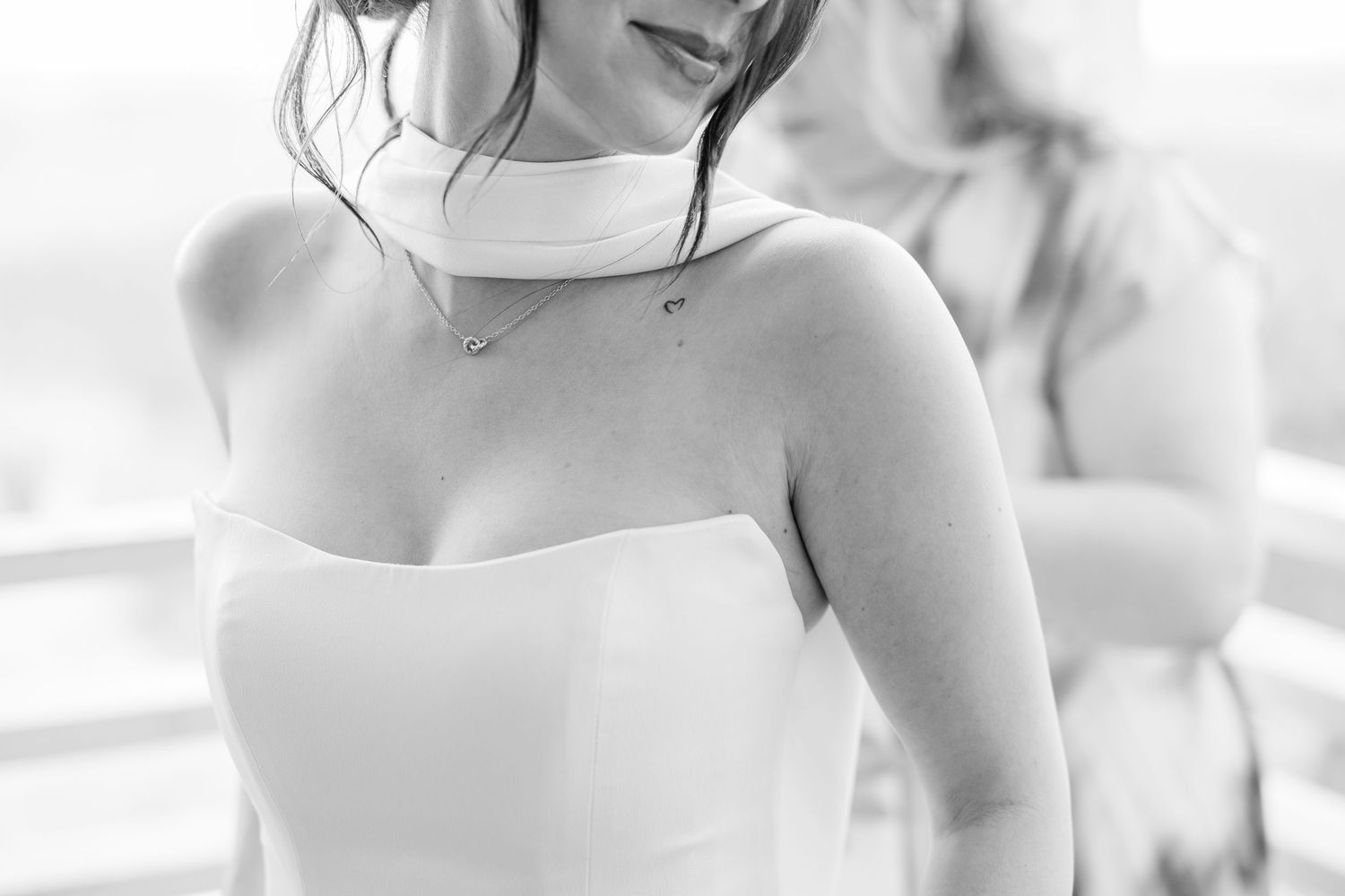 Black and white close-up of bride in strapless white gown wearing a delicate diamond necklace in Carolina Beach near Wilmington, NC.