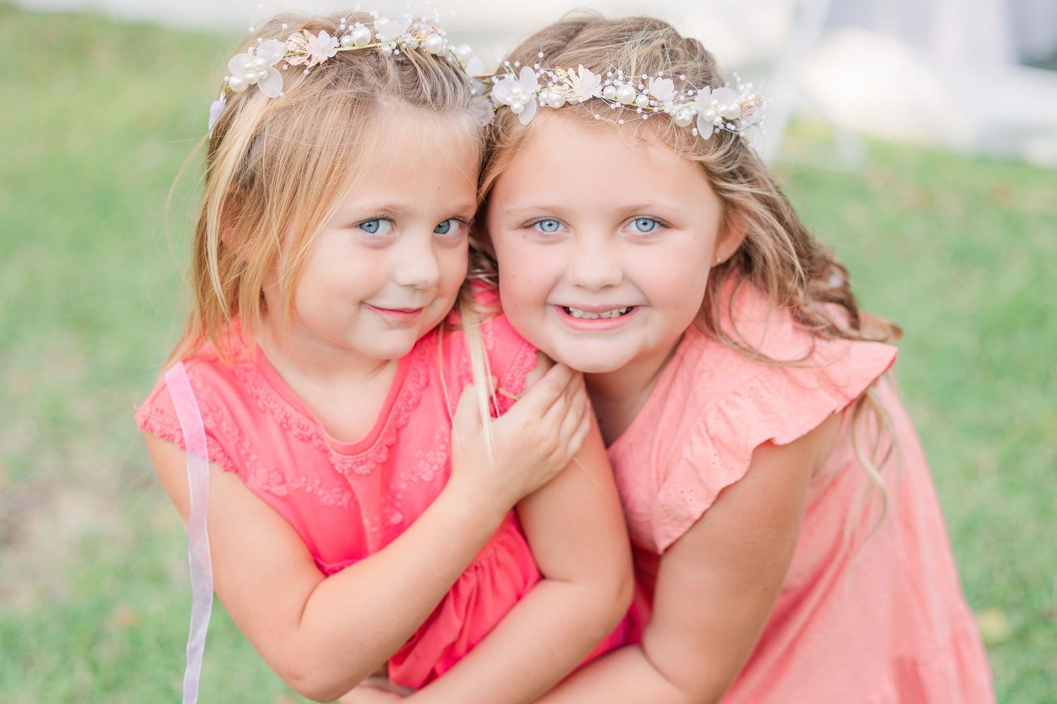 Young flower girls in coral dresses wedding groom bride wilmington photographer light and airy classic Wrightsville Beach