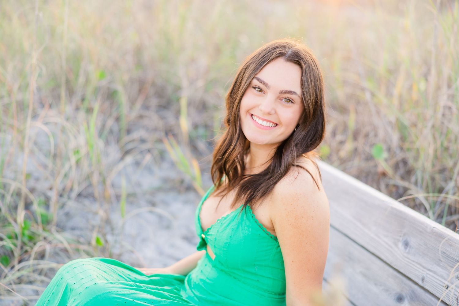 Candid beach photography series showcasing a flowy green dress in natural lighting.