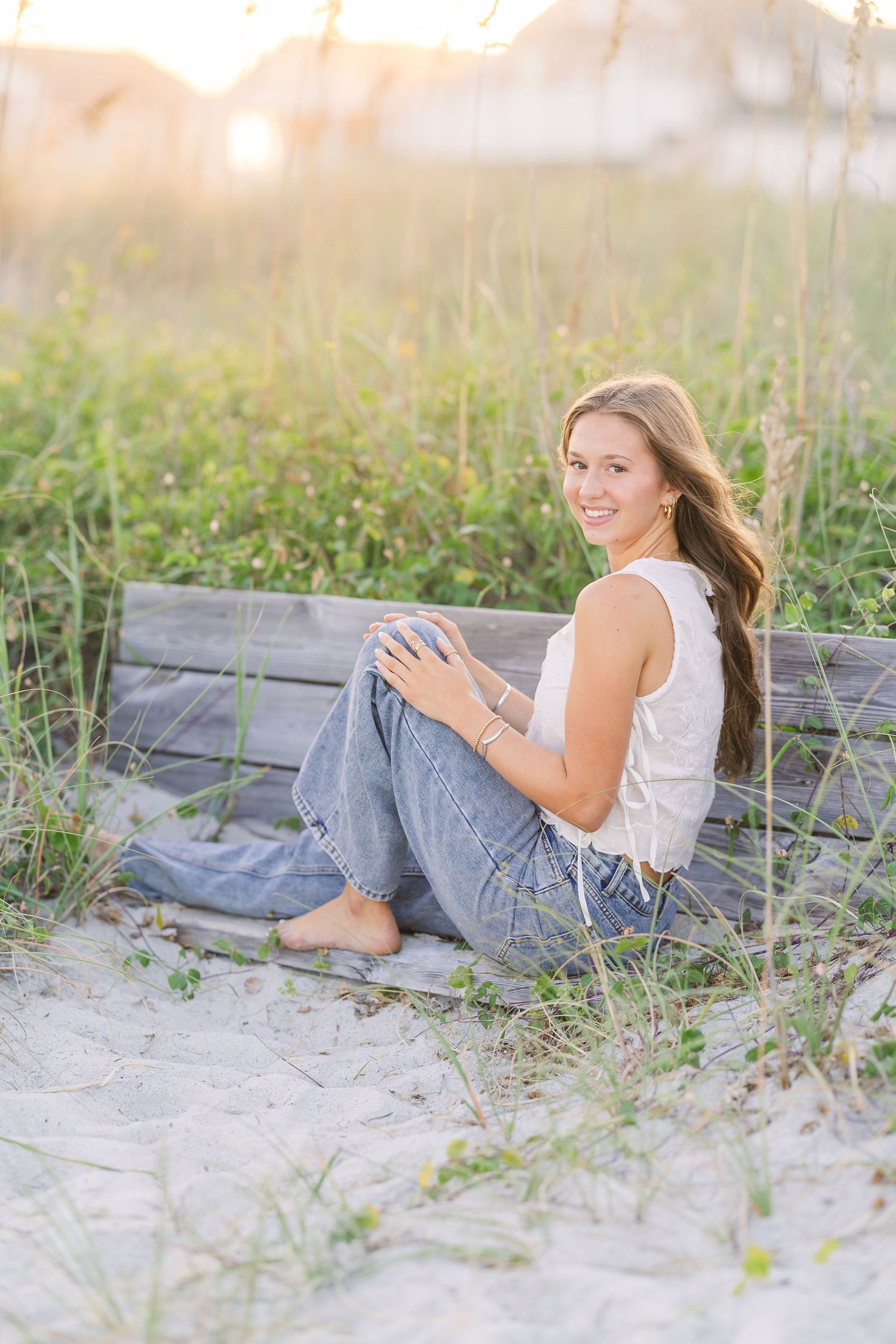 Casual beach photoshoot on sandy dunes during golden hour.