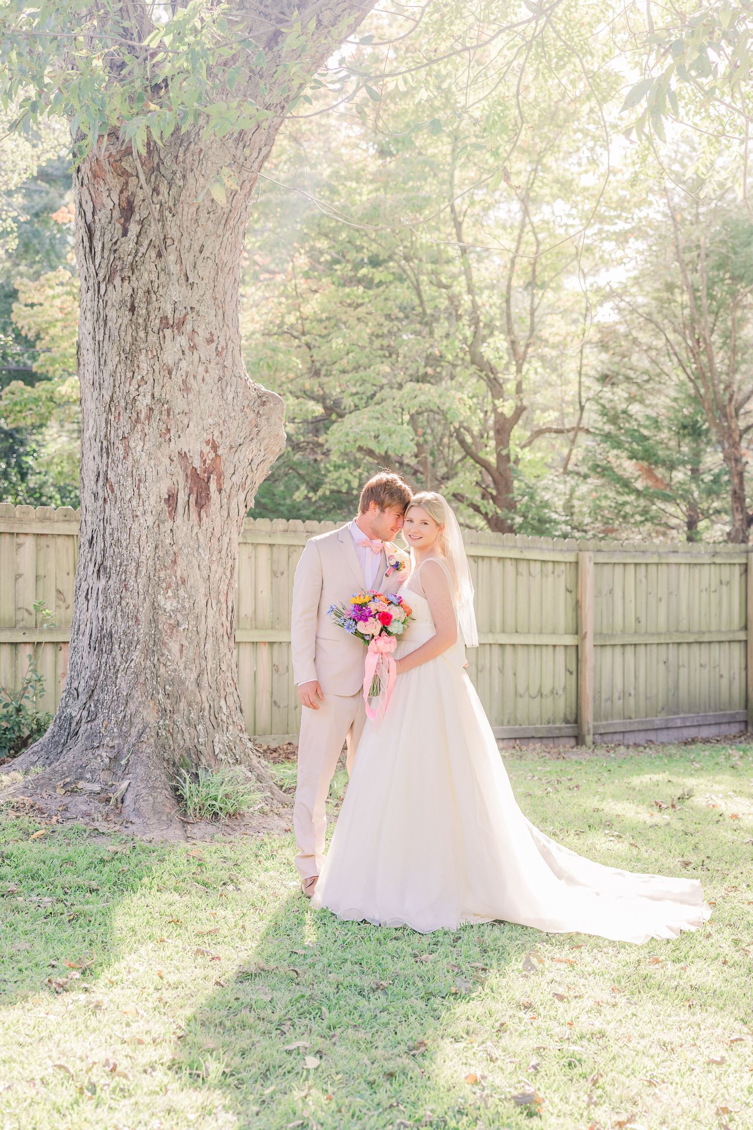 Romantic wedding photos captured in a sunlit garden wedding groom bride wilmington photographer light and airy classic Wrightsville Beach