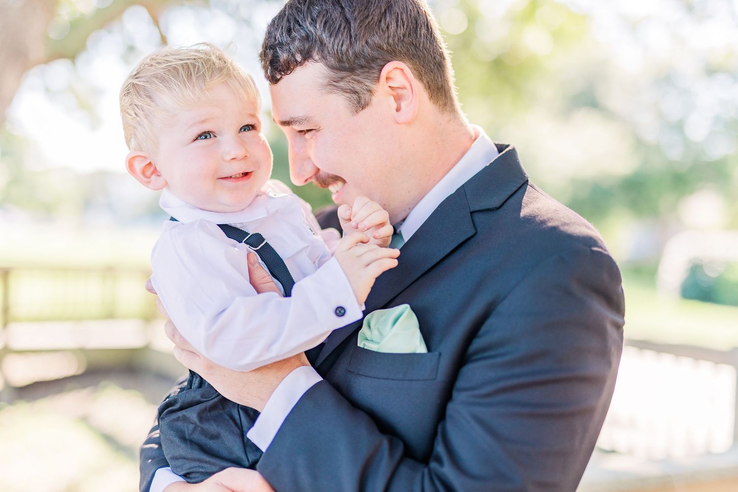 Tender moment between people in formal wear against a light-filled outdoor backdrop southport elopement wedding bride groom light and airy