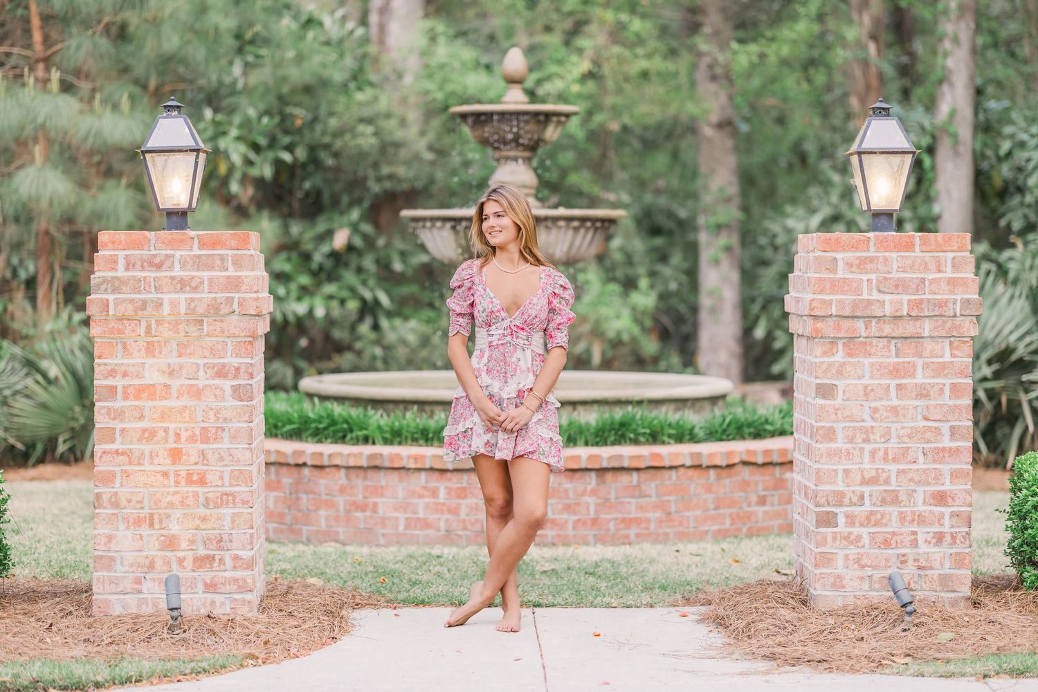 Fashion photography on brick wall pathway with garden landscaping.