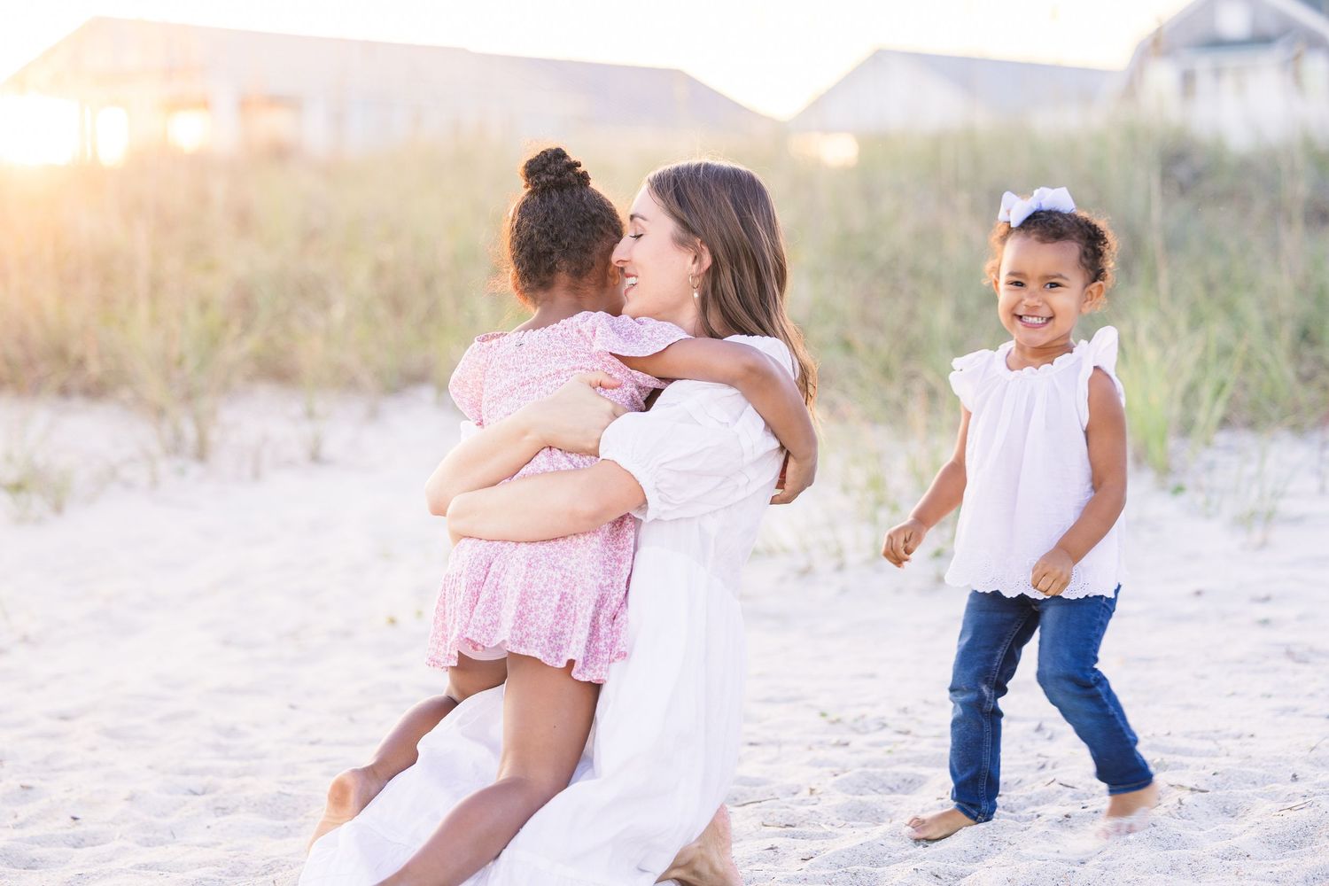 Loving family portrait session captured on a beautiful beach with natural lighting.