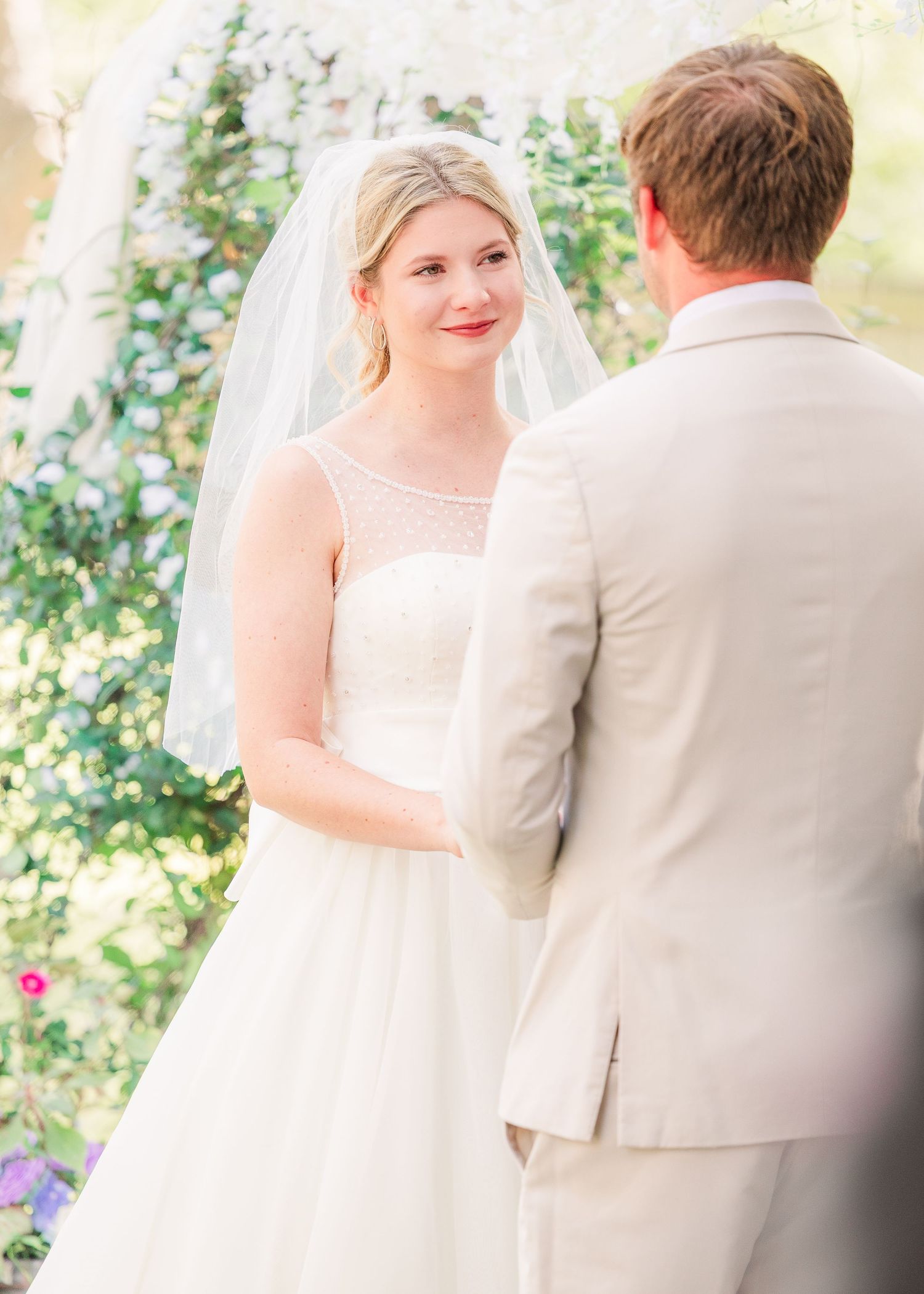 Intimate wedding ceremony moment under garden arbor wedding groom bride wilmington photographer light and airy classic Wrightsville Beach