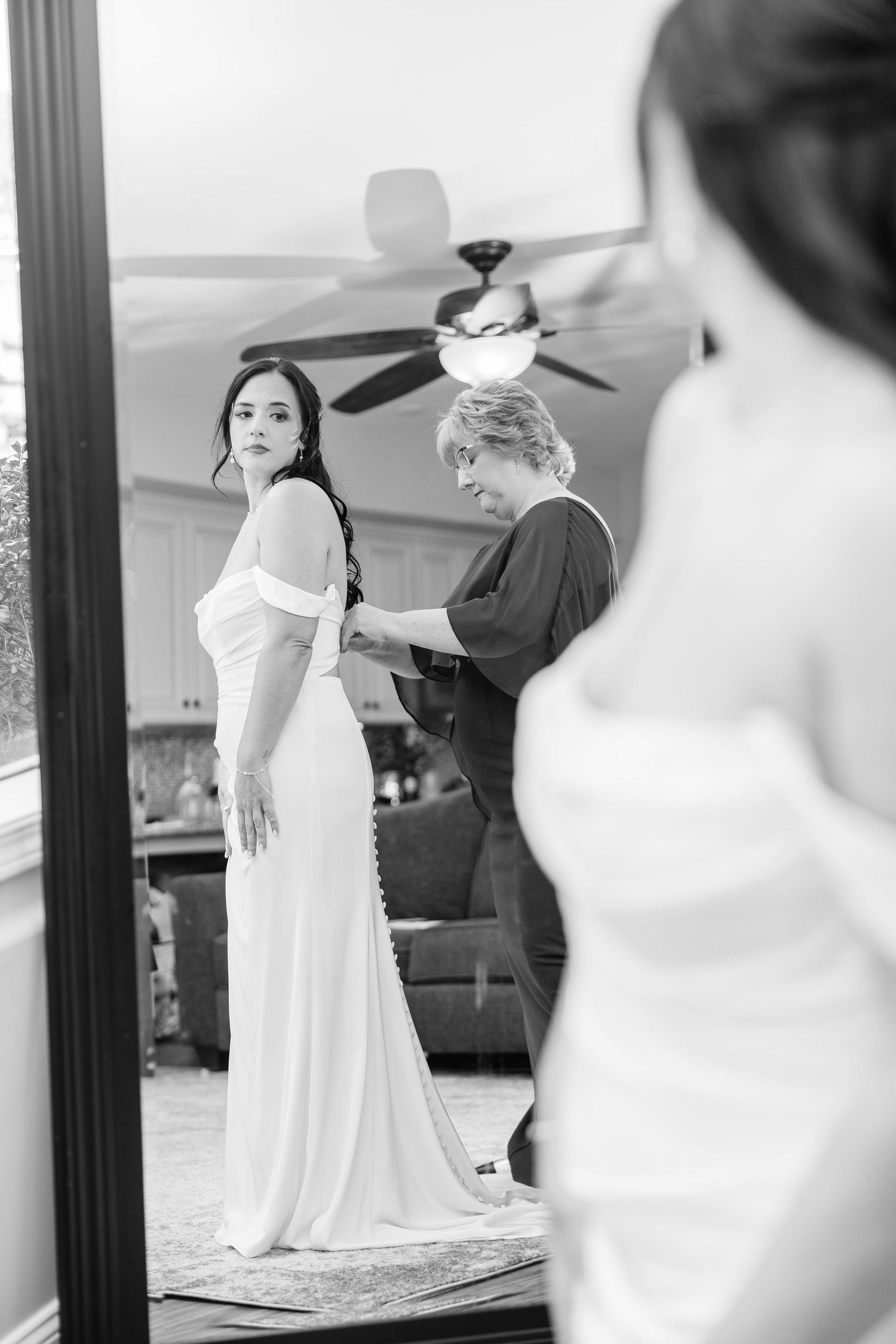 Wedding preparation scene in a bright room with white dresses visible wedding groom bride lake Gaston photographer light airy